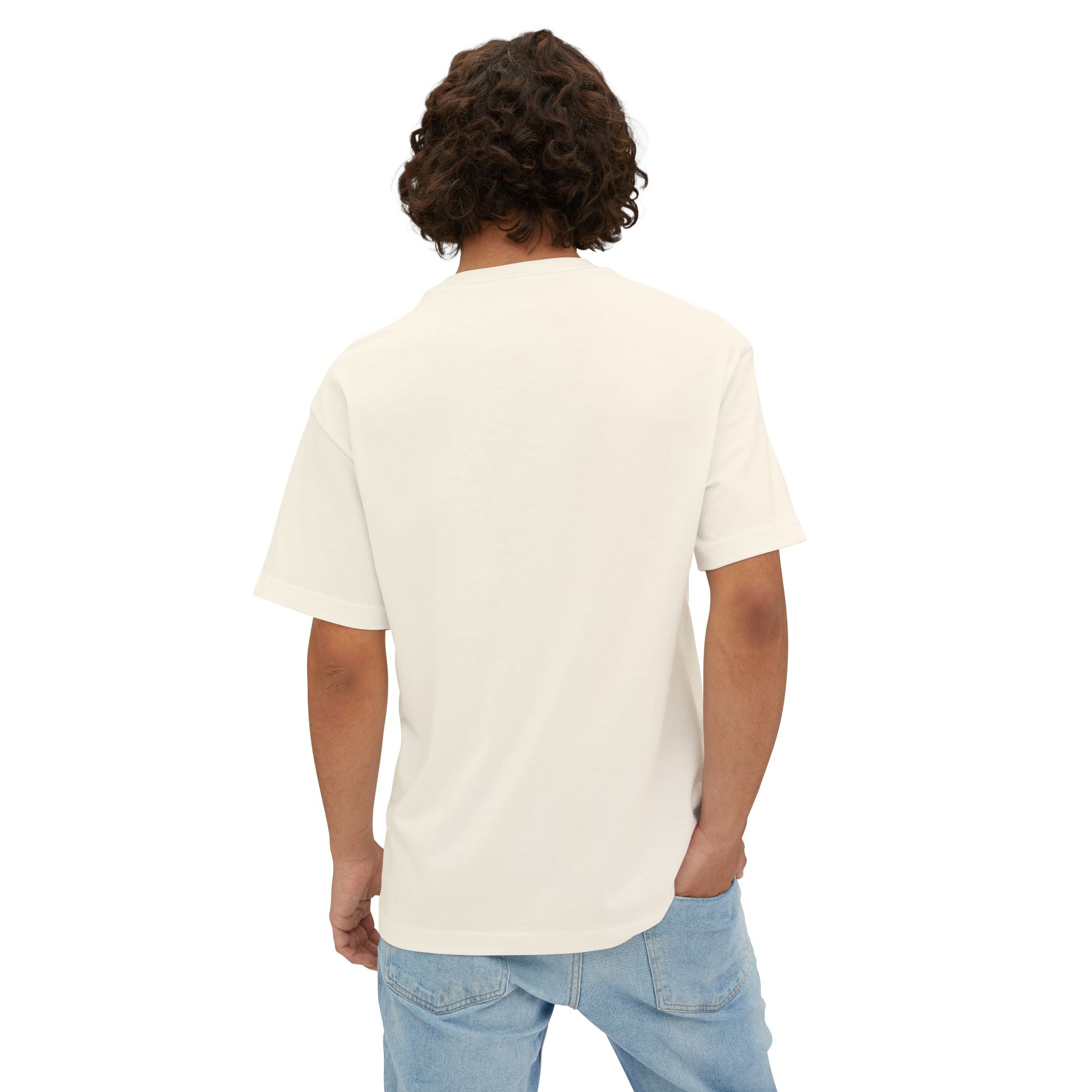 A person with curly brown hair, wearing the Crowned In Every Era - Unisex Oversized Boxy Tee in white and light blue jeans, stands with their back to the camera against a white background.