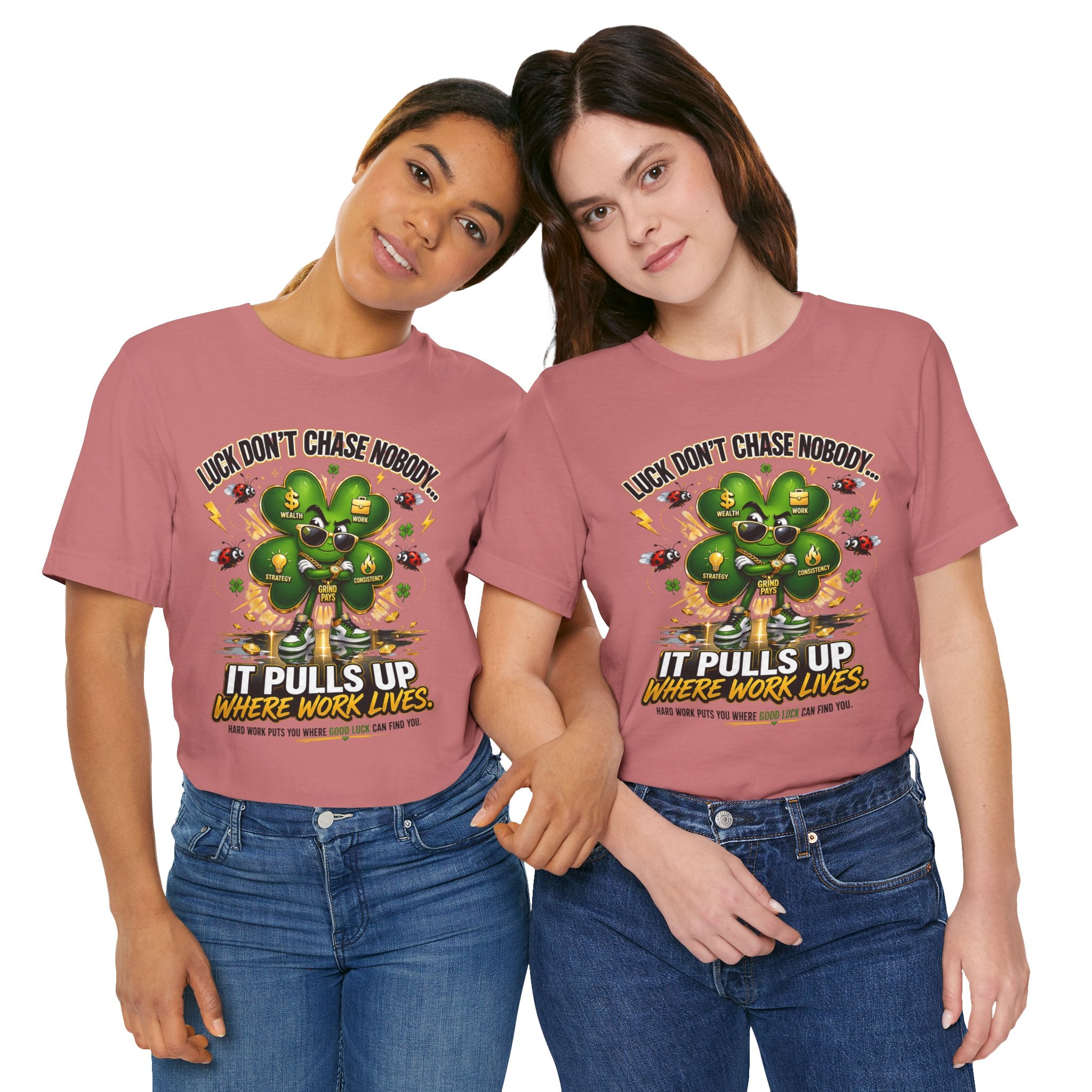 Two women stand together in matching TimeWarp Drip Lucky Clover "Pulls Up Lives" T-shirts (S–3XL), featuring a four-leaf clover with coins and the text: Luck don’t chase nobody… It pulls up where work lives.