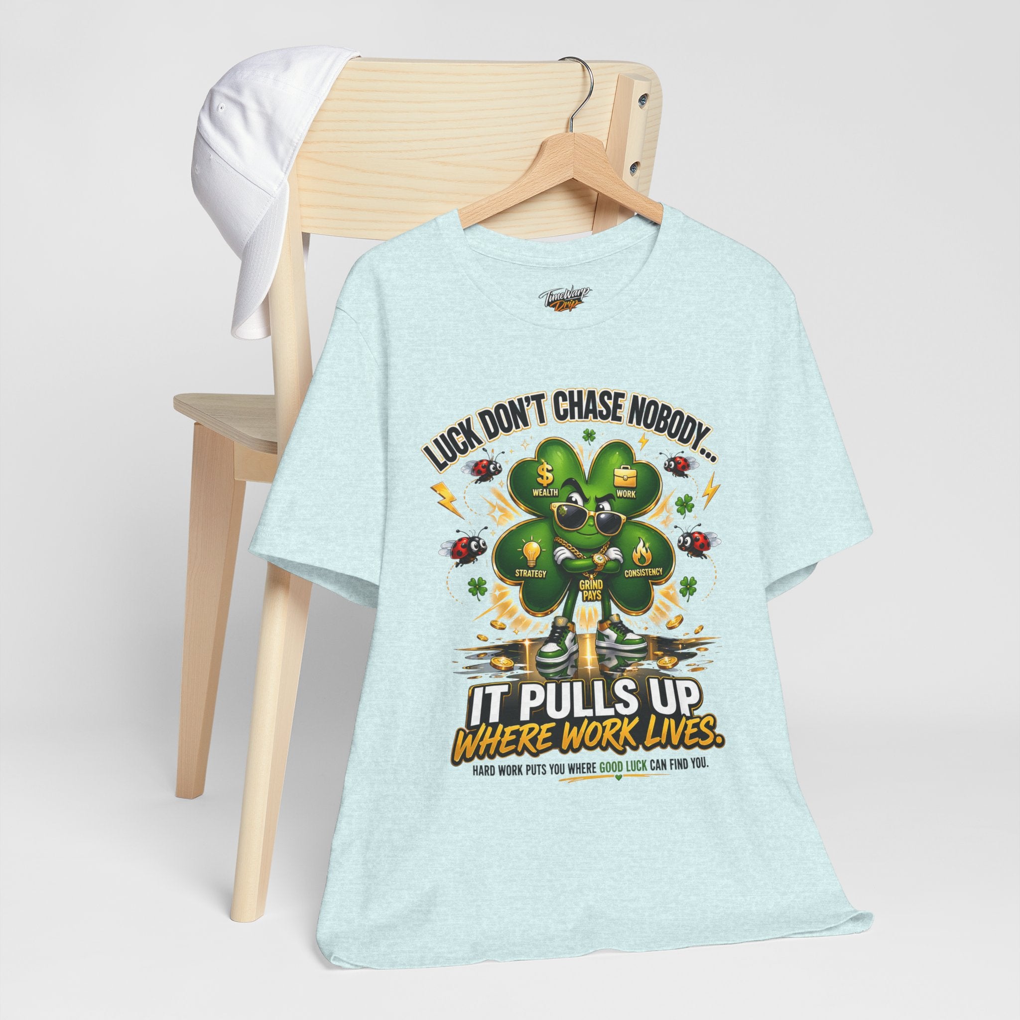 TimeWarp Drip Luck Don't Chase Nobody black 4-Leaf Clover tee flexes on a wooden chair, stuntin' next to a crisp white cap. Street drip!. streetwear apparel