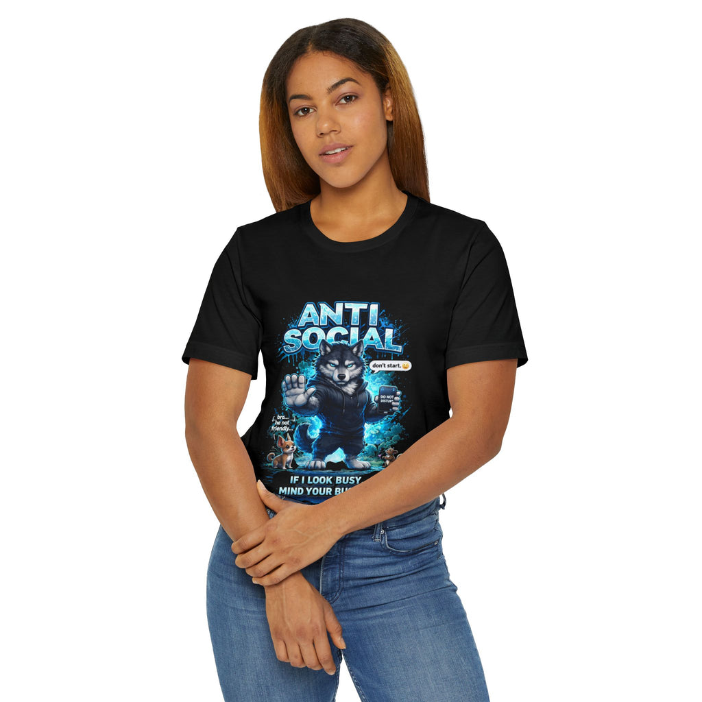 A woman with long hair stands with arms crossed, wearing the Timewarp Drip Anti Social Wolf T-Shirt — Funny Introvert Graphic Tee, featuring an angry black cat and "If I look busy, mind your business" text, paired with blue jeans.