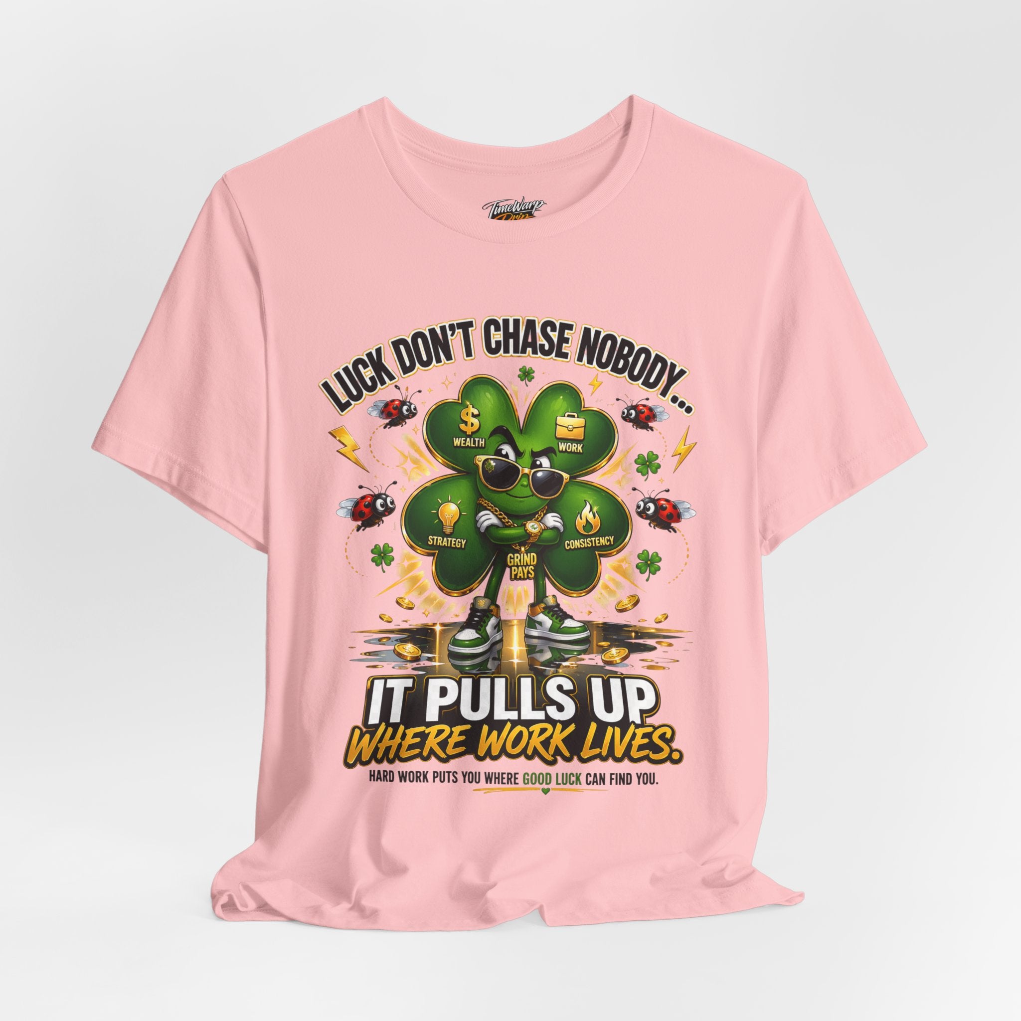 The TimeWarp Drip "Lucky Clover, Pulls Up Lives" Graphic T-Shirt features a cool four-leaf clover in shades with coins and ladybugs, plus the text: Luck don’t chase nobody... Hard work puts you where good luck can find you. Sizes S–3XL.