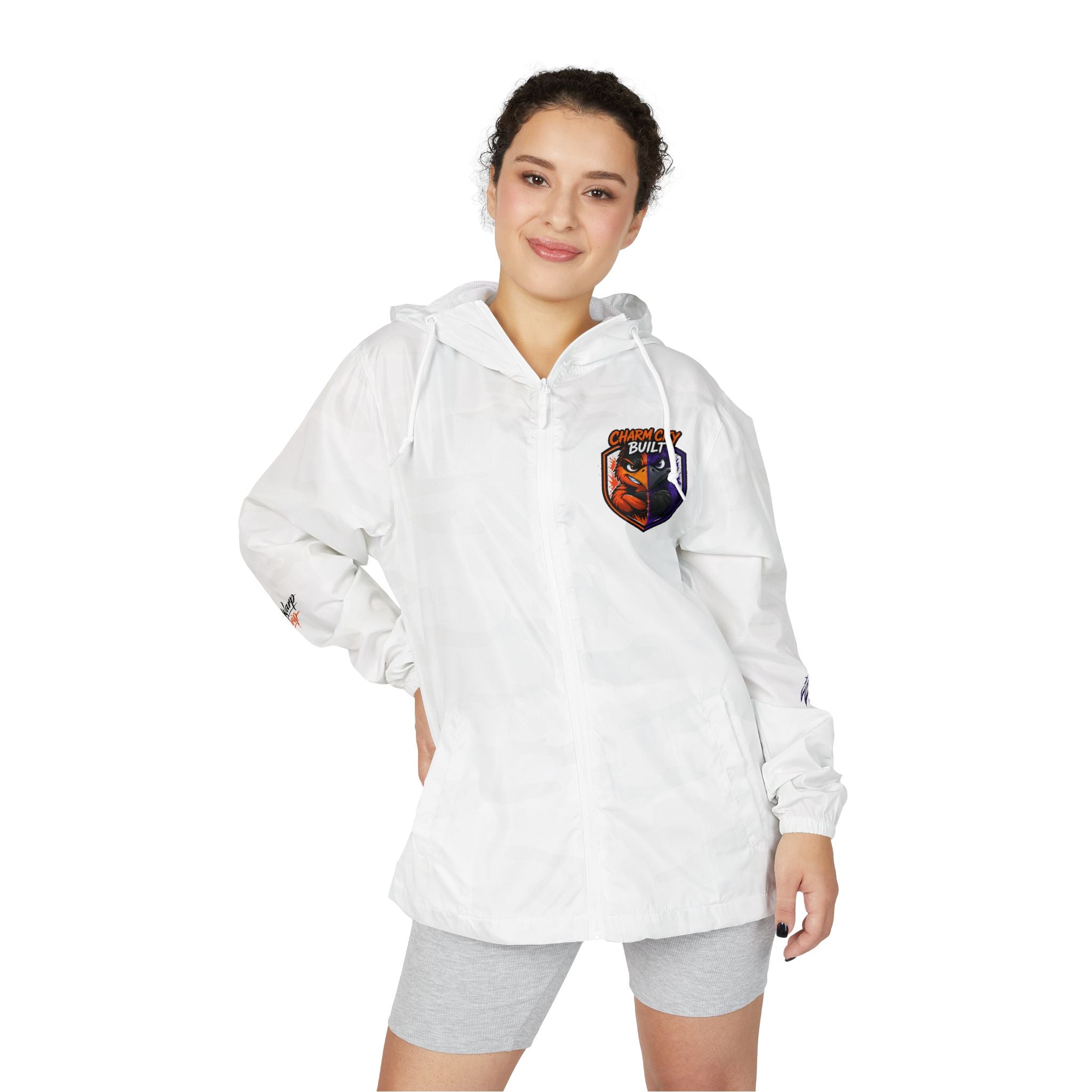 TimeWarp Drip Confident woman rocks Charm City split two-tone Bird windbreaker jacket and light gray shorts, flashing a bold smile. 