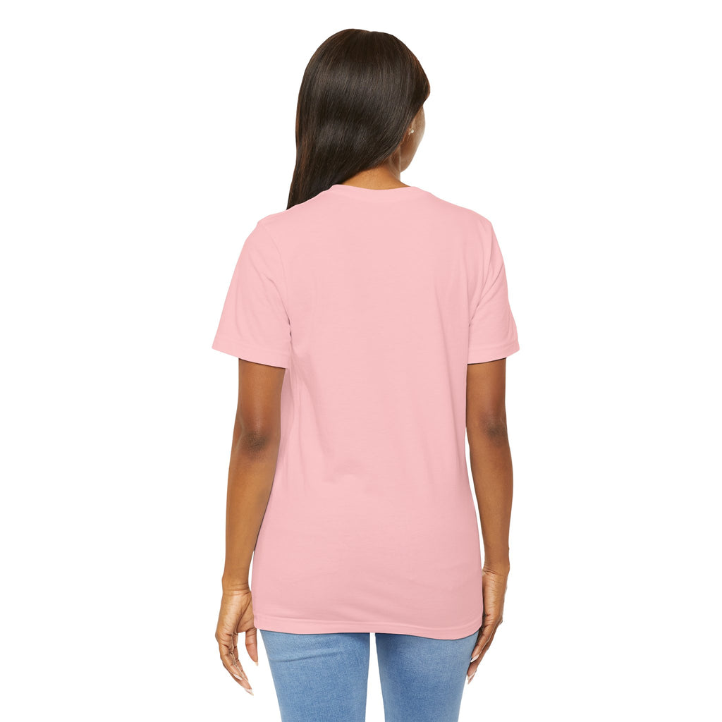 A person with long brown hair stands with their back to the camera, wearing TimeWarp Drip’s Lucky Clover "Pulls Up Lives" Graphic T-Shirt (S–3XL) in light pink and light blue jeans against a plain white background.