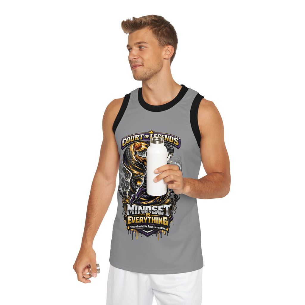A man in a Court of Legends (Grey) Basketball Jersey with a Mindset Is Everything graphic, made from moisture-wicking polyester, smiles as he holds a white water bottle and looks to the side.