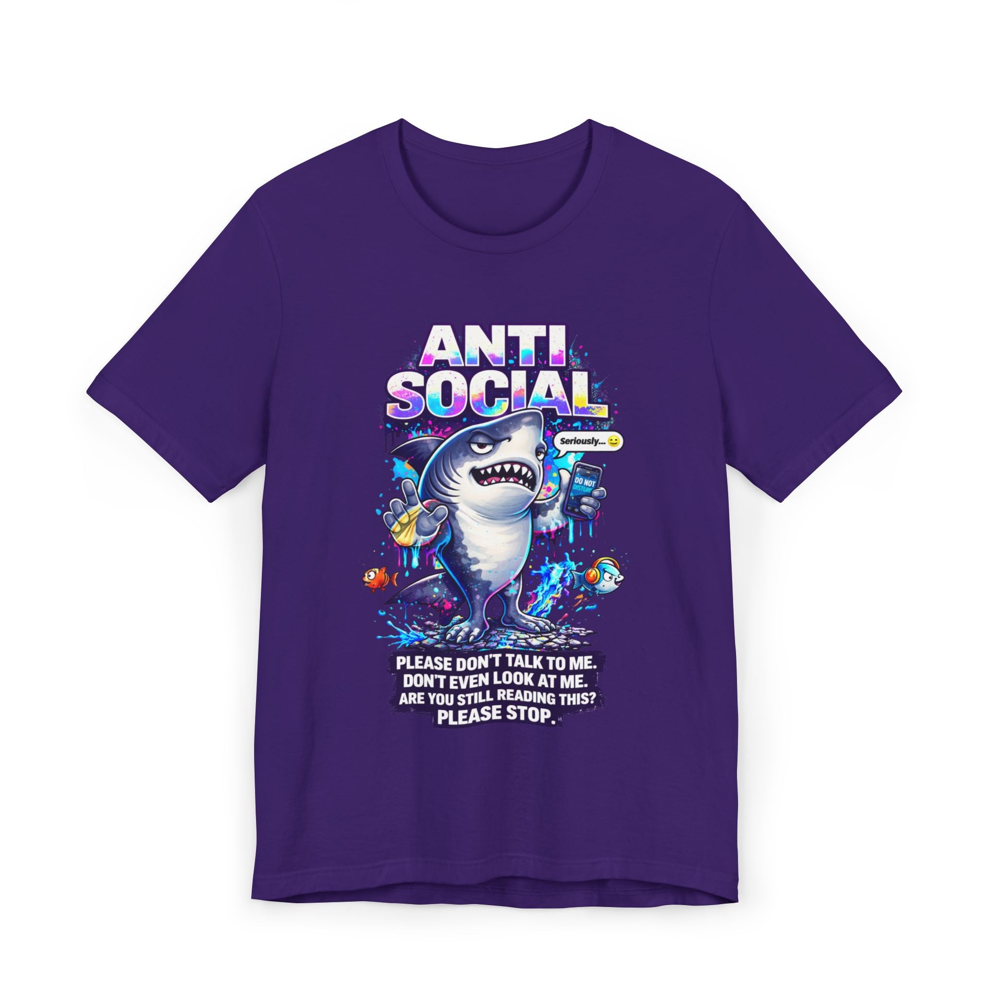 The Anti Social Shark T-Shirt — Funny Introvert Graphic Tee is a purple shirt with a cartoon shark wearing headphones and holding a phone, surrounded by fish. The text reads: "ANTI SOCIAL. Please don't talk to me. Don't even look at me. Please stop.