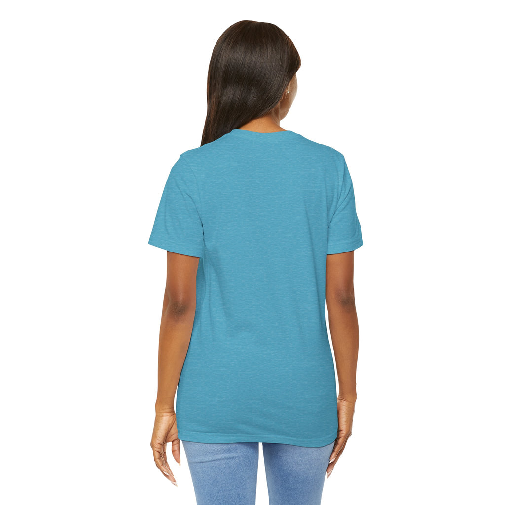 A woman with long dark hair faces away from the camera, wearing a blue TimeWarp Drip Lucky Clover "Pulls Up Lives" Graphic T-Shirt and light blue jeans against a white background. This tee is available in sizes S–3XL.
