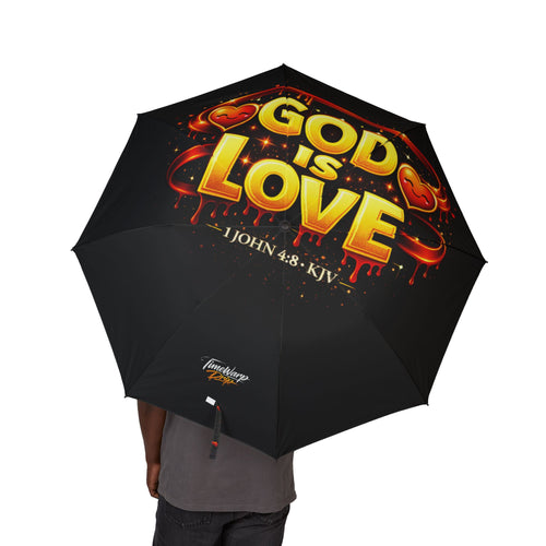 A person holds the "God Is Love" Design (Semi‑Automatic) Foldable Black Umbrella, featuring bold golden text with 1 John 4:8, KJV, red hearts, decorative accents, and a large canopy for full coverage.
