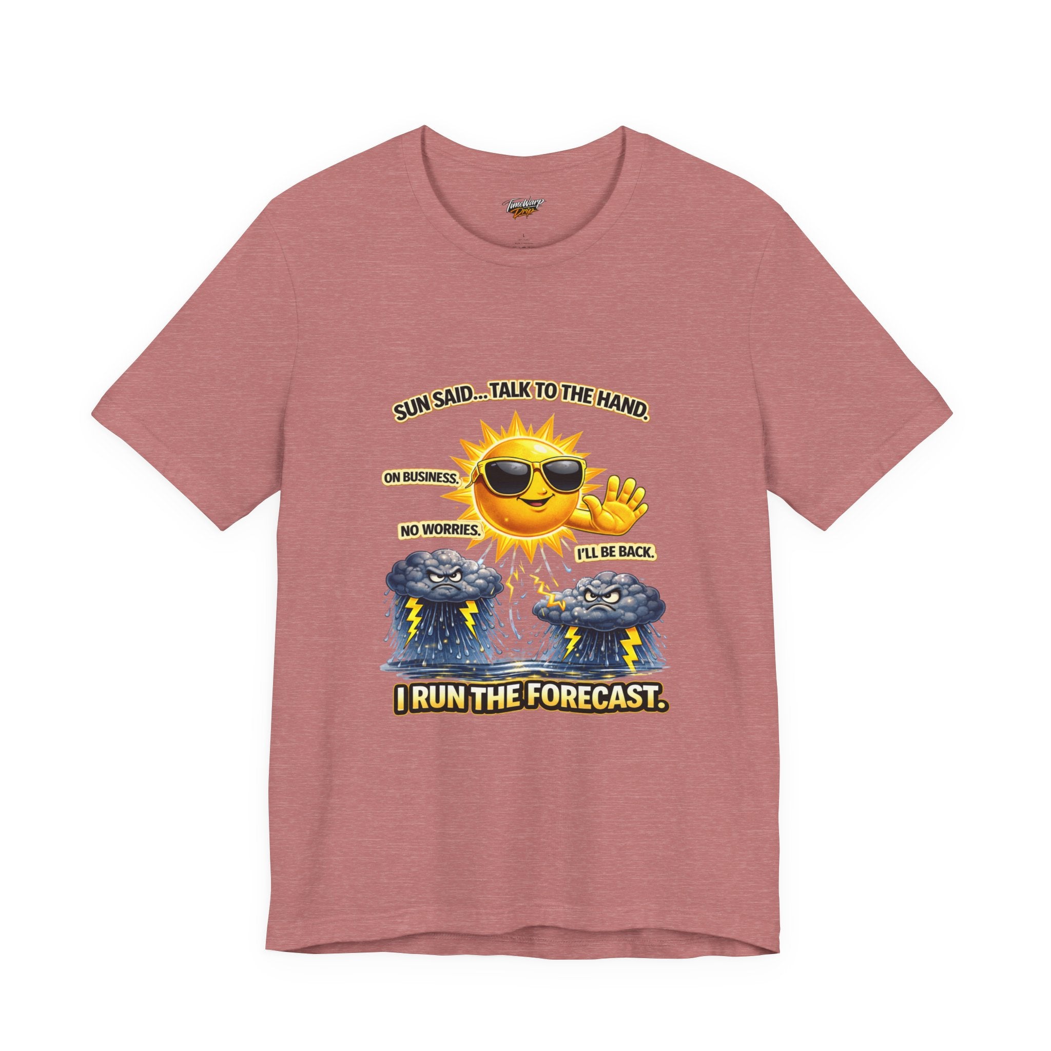 The Calm Energy Vibes T-Shirt by Printify features a pink lightweight design with a cartoon sun in sunglasses saying “I run the forecast,” radiating CEO Energy as it waves at sad storm clouds labeled “No worries” and “I’ll be back. On business.”.