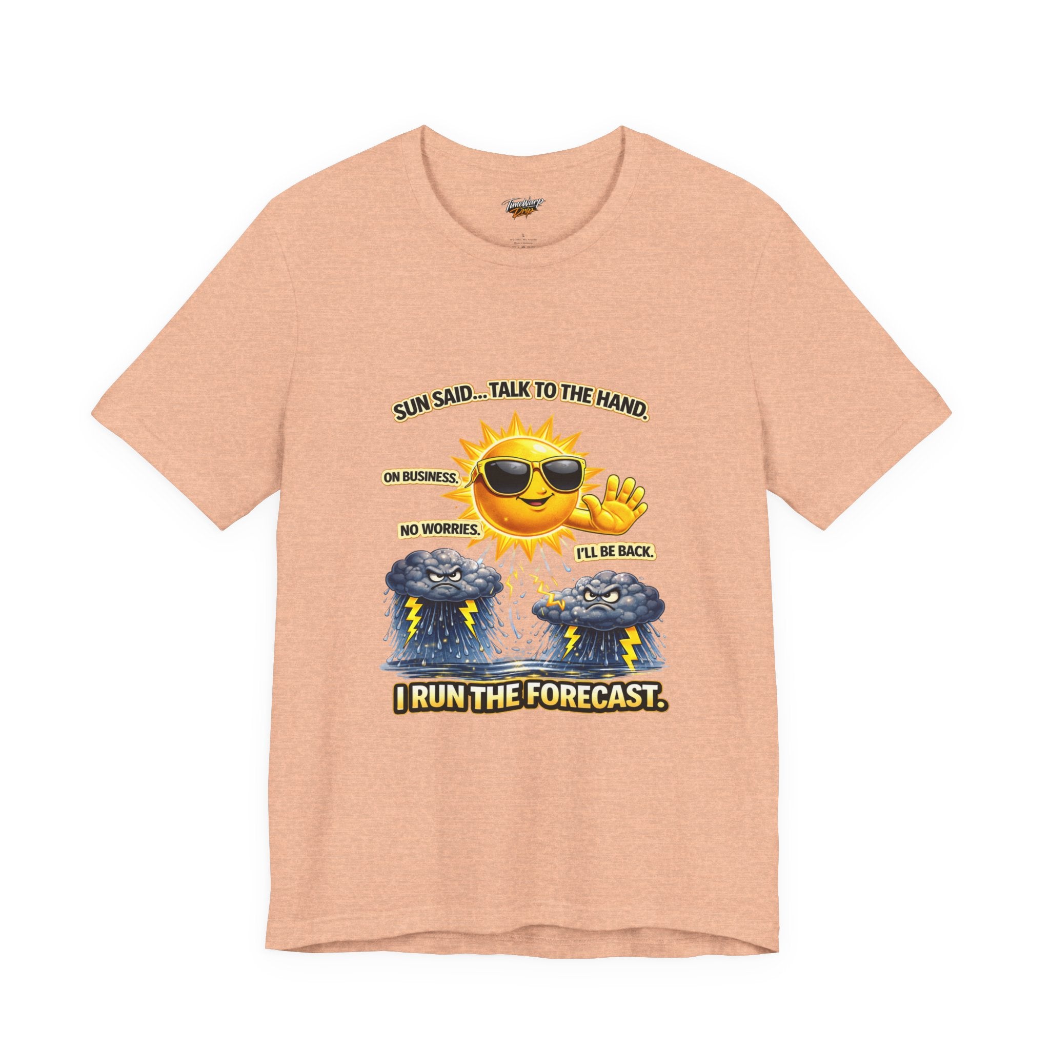 The Calm Energy Vibes T-Shirt comes in peach, showcasing a cartoon sun with CEO Energy—sunglasses on, hand raised—above two sad clouds. Text reads: "Sun said... talk to the hand. On business. I run the forecast.