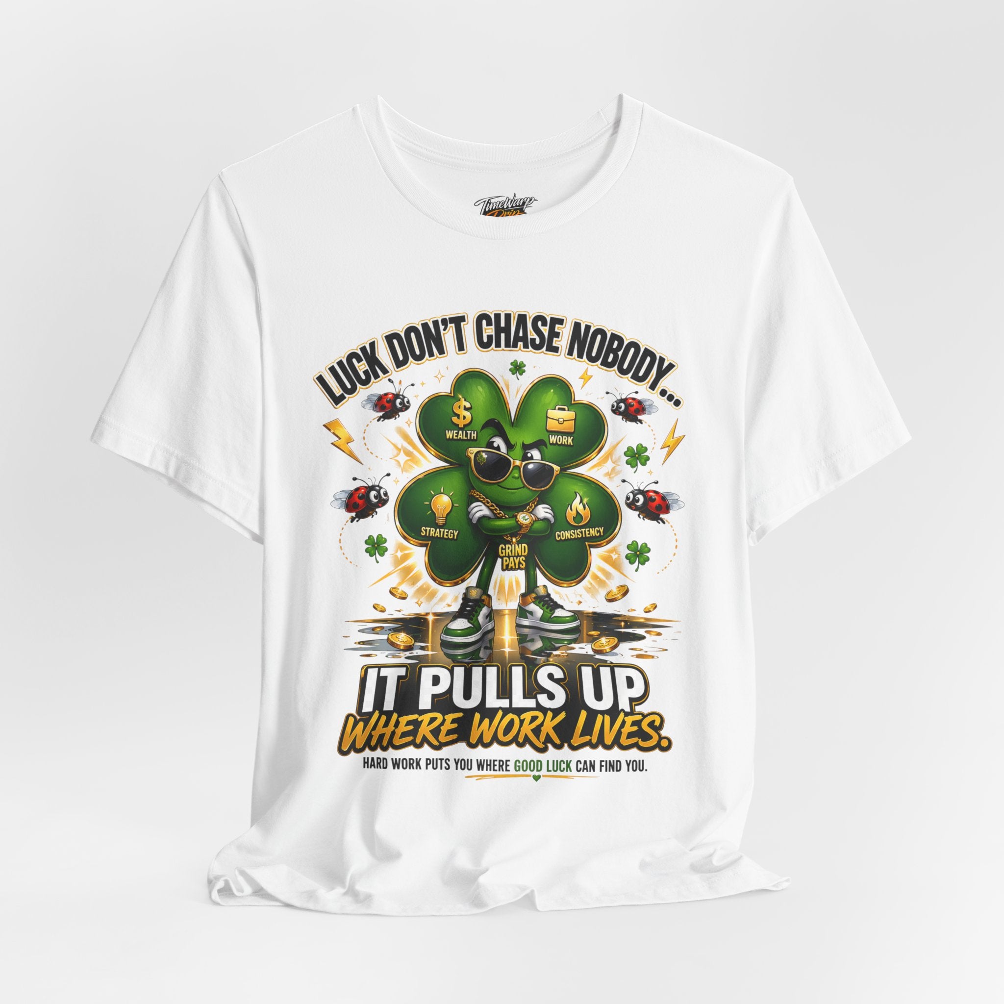 TimeWarp Drip Lucky Clover "Pulls Up Lives" Graphic T-Shirt in S-3XL. Features a cartoon clover with sunglasses, gold chains & cash, plus the bold slogan: “Luck don’t chase nobody—it pulls up where work lives.”.