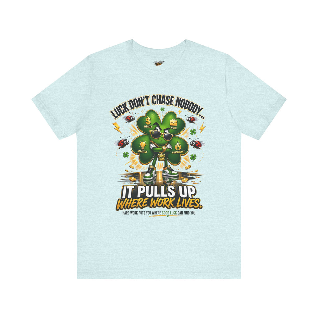 The TimeWarp Drip Lucky Clover "Pulls Up Lives" Graphic T-Shirt features a clover-shaped tree with gold coins and icons, plus the motto: Luck doesn’t chase nobody. It pulls up where work lives. Sizes: S–3XL.