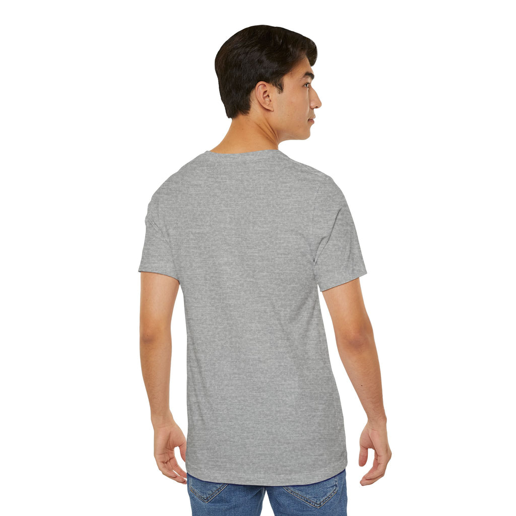 A young man with short dark hair is standing with his back to the camera, wearing the Anti Social Shark T-Shirt — Funny Introvert Graphic Tee in light gray and blue jeans against a white background.