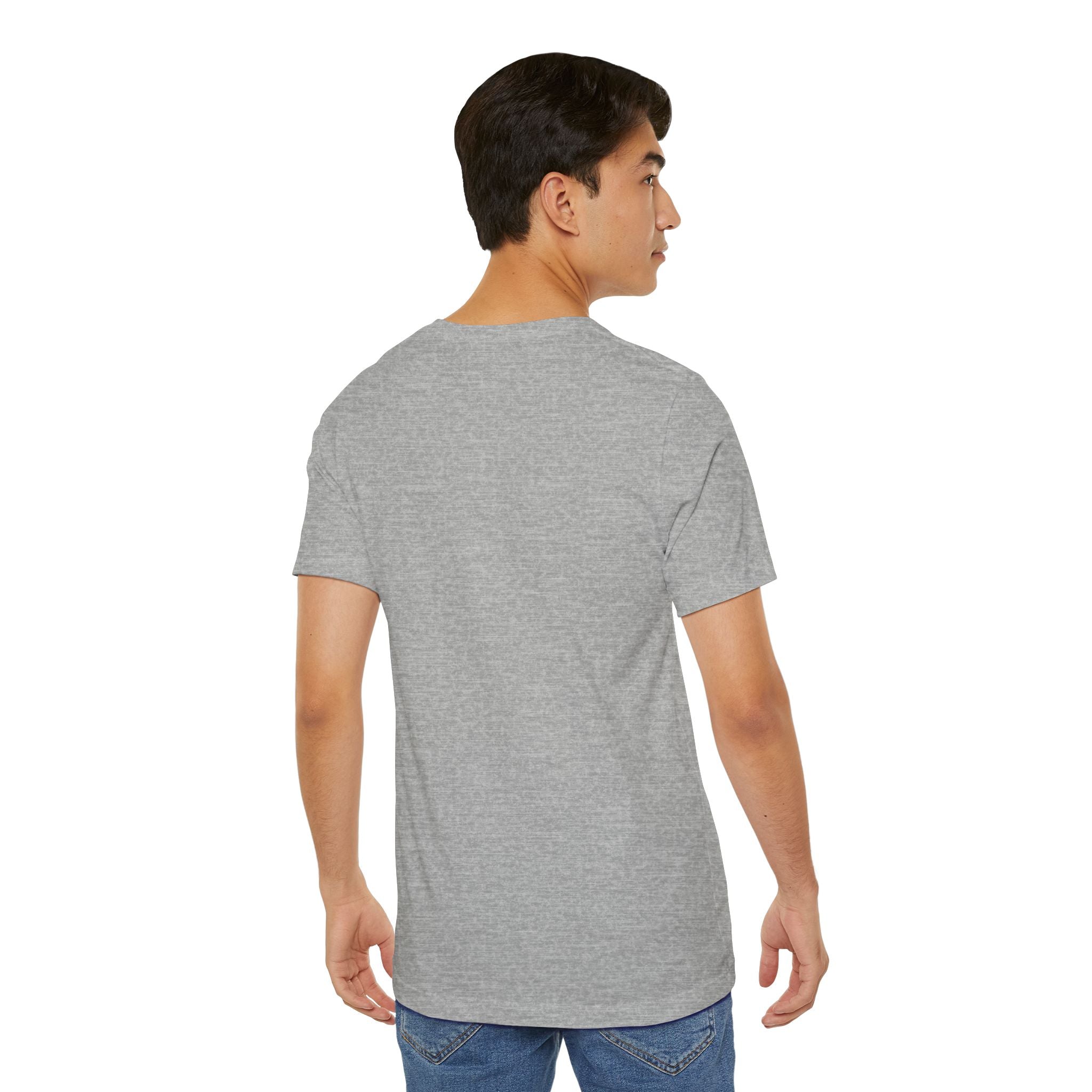 A young man with short dark hair is standing with his back to the camera, wearing the Anti Social Shark T-Shirt — Funny Introvert Graphic Tee in light gray and blue jeans against a white background.