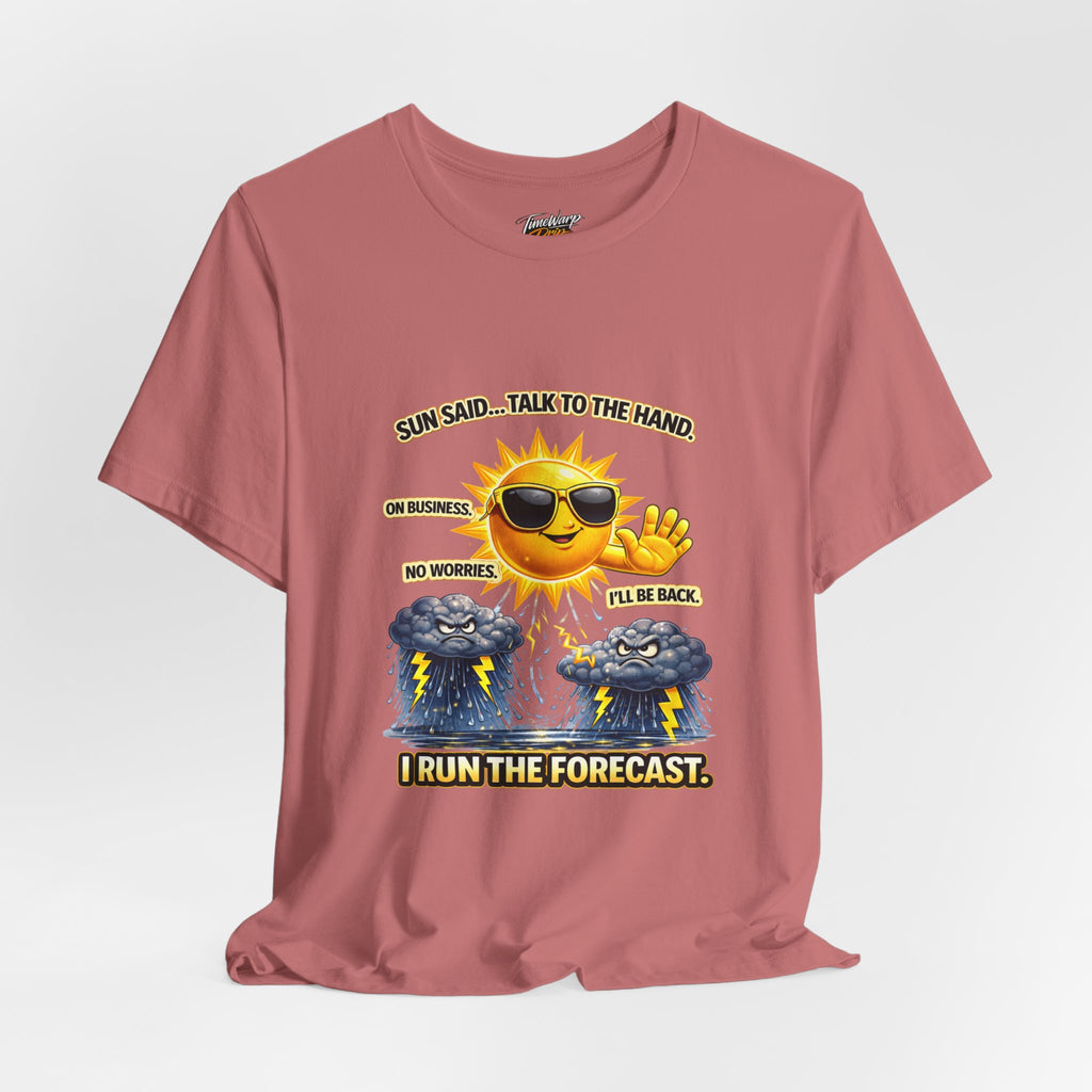 The TimeWarp Drip Calm Energy Vibes T-Shirt—"I Run the Forecast" CEO Energy—features a pink Airlume cotton tee with a cartoon sun in sunglasses above storm clouds and text: Sun said... talk to the hand. On business. No worries. I’ll be back.
