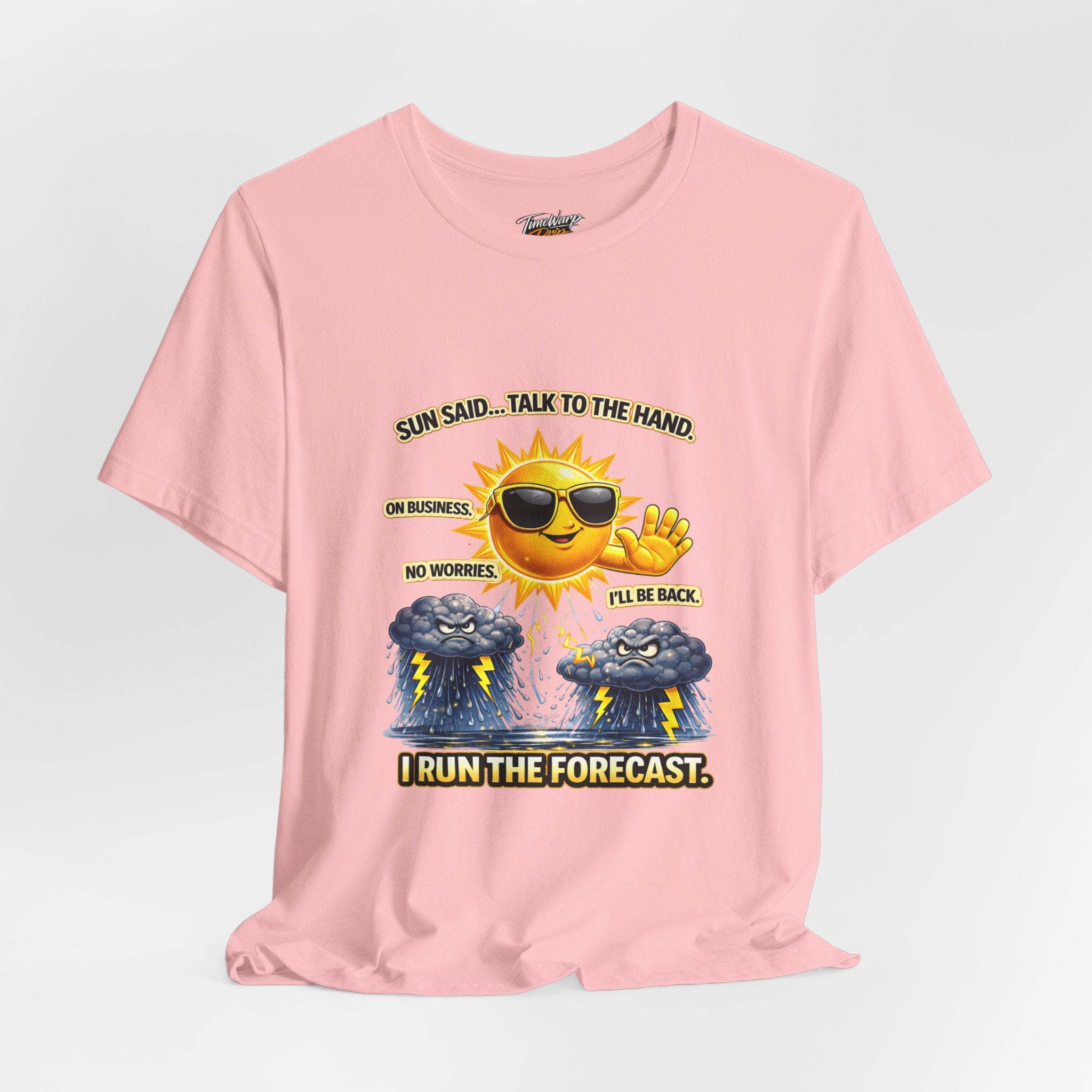 The Calm Energy Vibes T-Shirt by Printify features a soft pink Airlume cotton tee with a smiling sun in sunglasses, CEO Energy, and storm clouds below the text: Sun said... Talk to the hand. I run the forecast.