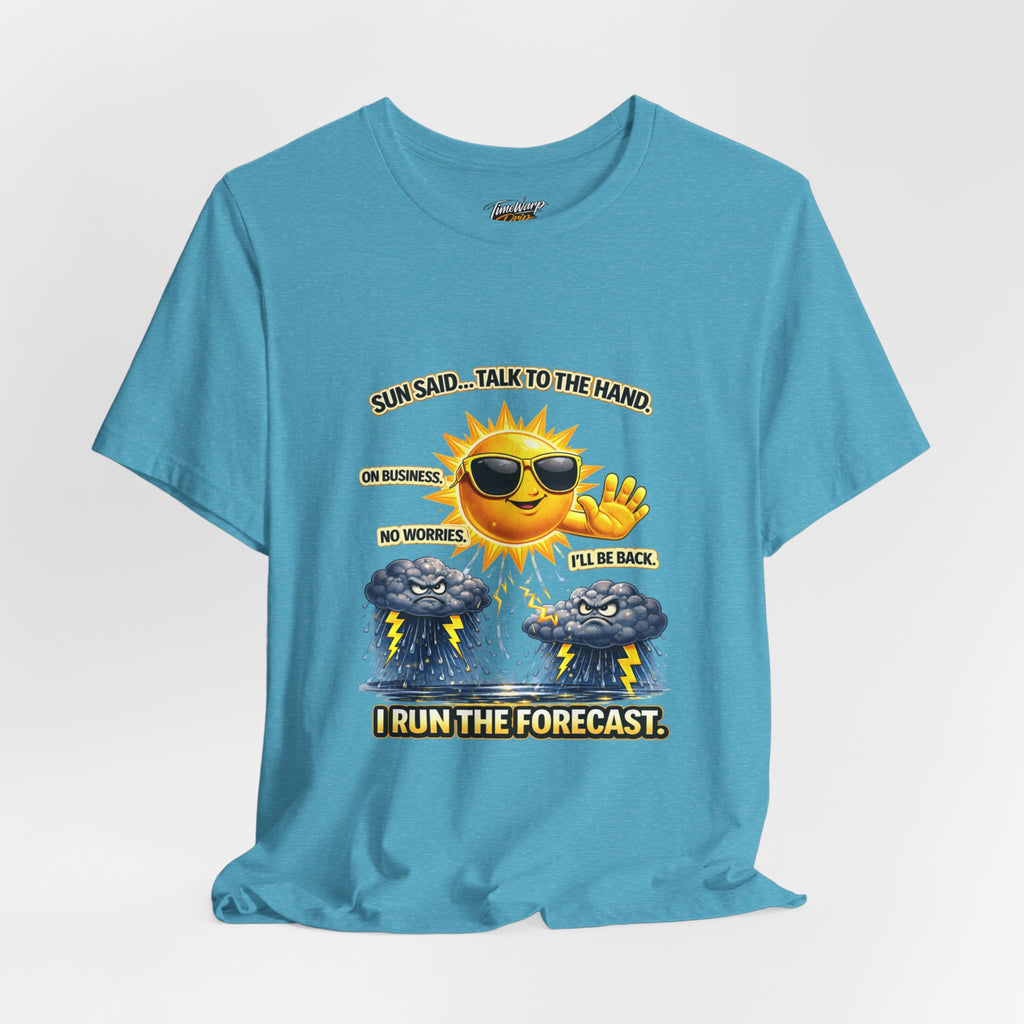 The TimeWarp Drip Calm Energy Vibes T-Shirt—"I Run the Forecast" CEO Energy—features a blue, lightweight Airlume cotton tee with a cartoon sun in shades and uplifting text: Sun said... talk to the hand. I run the forecast.