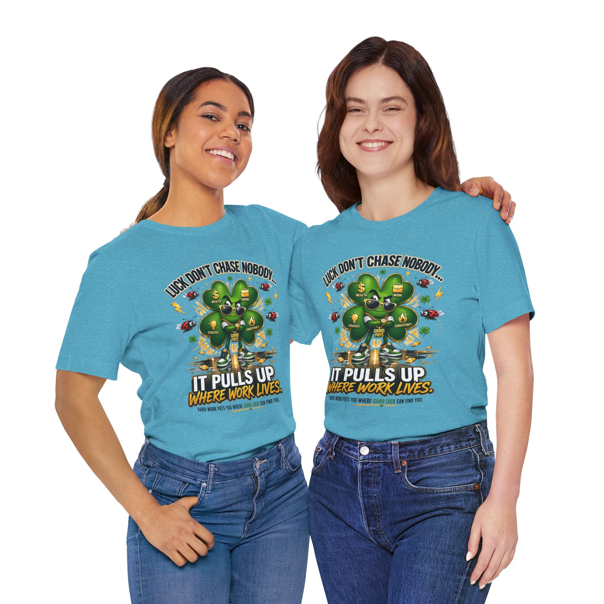 Two women wear matching TimeWarp Drip Lucky Clover "Pulls Up Lives" Graphic T-Shirts (S-3XL) featuring a green truck and the phrase "Luck don't chase nobody. It pulls up where work lives." They stand together against a white background.