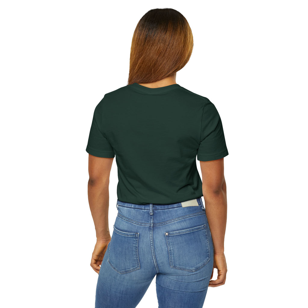A person with long, straight hair stands with their back to the camera, wearing a dark green Anti Social Shark T-Shirt — Funny Introvert Graphic Tee and blue jeans.