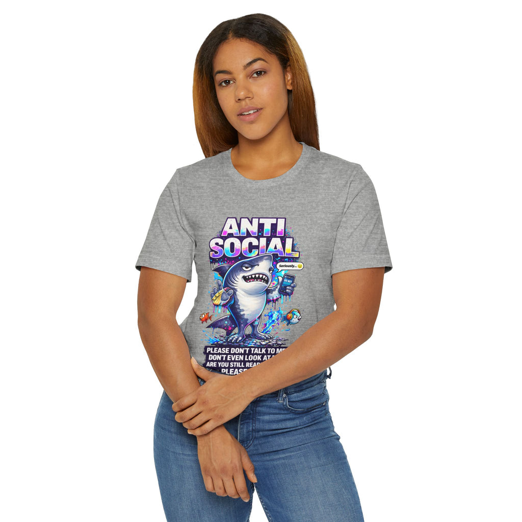 A woman with straight brown hair wears the Anti Social Shark T-Shirt — Funny Introvert Graphic Tee, a unisex cotton tee featuring a bold cartoon shark and text, standing against a white background to showcase its playful design.