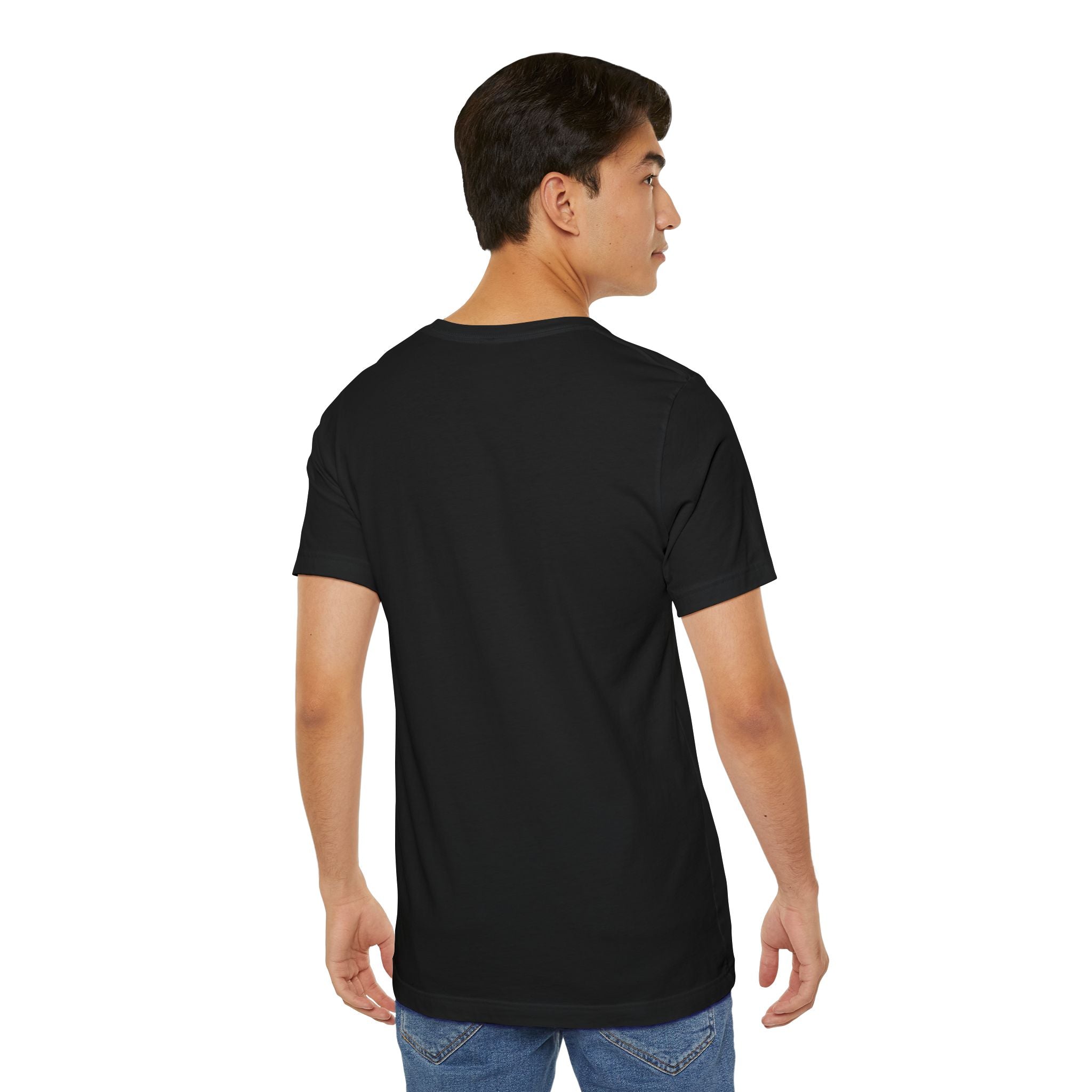 A young man with short dark hair stands with his back to the camera, wearing blue jeans and a plain black Timewarp Drip Anti Social Wolf T-Shirt—Funny Introvert Graphic Tee—against a white background, glancing over his left shoulder.
