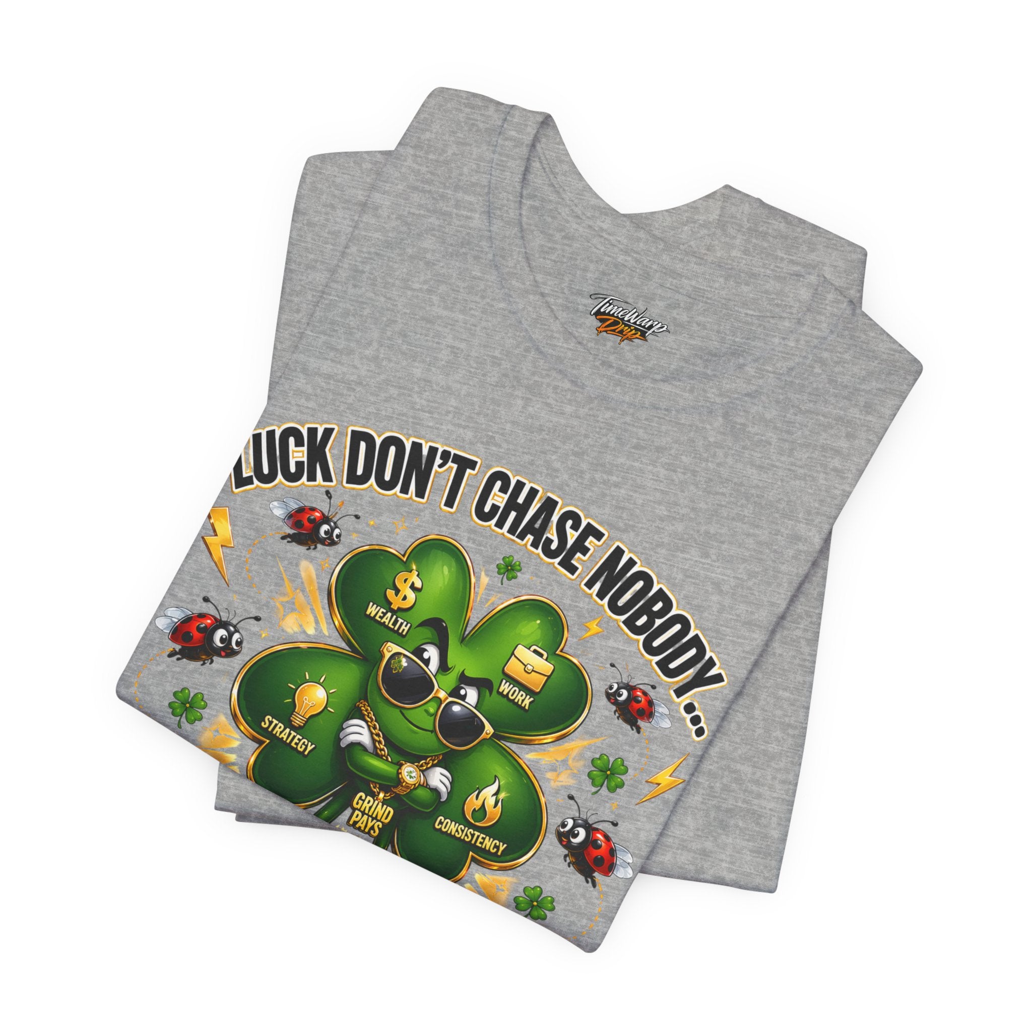 The TimeWarp Drip Lucky Clover "Pulls Up Lives" Graphic T-Shirt, available in S-3XL, features a cartoon clover in sunglasses with wealth and luck symbols, plus the phrase “Luck don’t chase nobody…” and words like “wealth” and “win.”.
