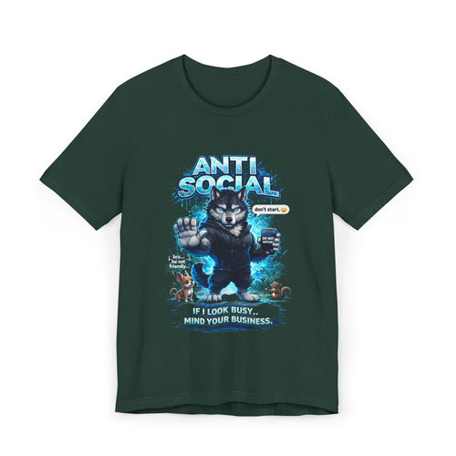 The Anti Social Wolf T-Shirt by Timewarp Drip is a dark green streetwear tee with a cartoon wolf in a hoodie, blue "ANTI SOCIAL" text, and the phrase "IF I LOOK BUSY… MIND YOUR BUSINESS." Blue graphics and small icons add extra attitude.