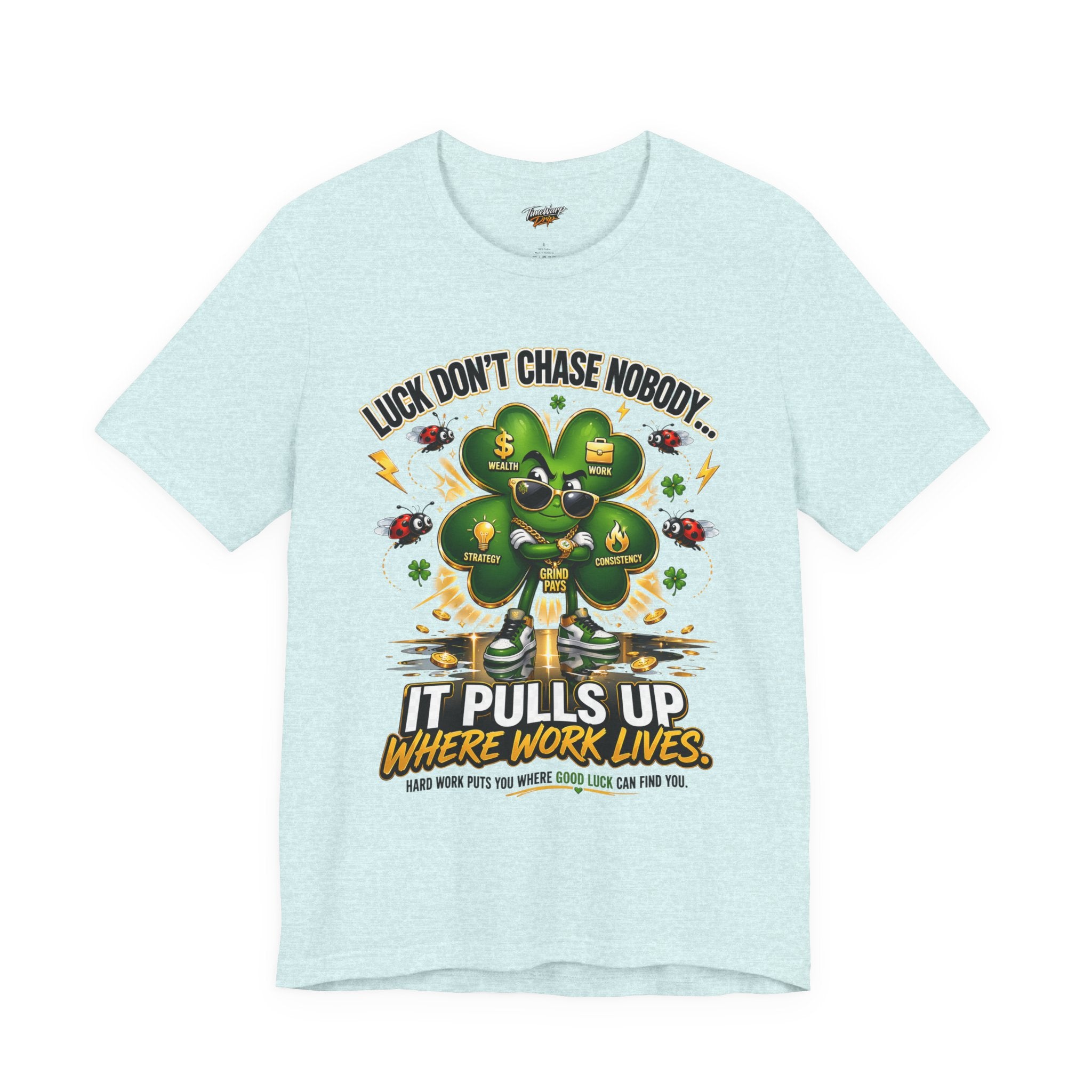 The TimeWarp Drip Lucky Clover "Pulls Up Lives" Graphic T-Shirt is light blue (S-3XL) with a green four-leaf clover, icons for success, health, goals & money, and the text: "Luck don’t chase nobody... It pulls up where work lives.