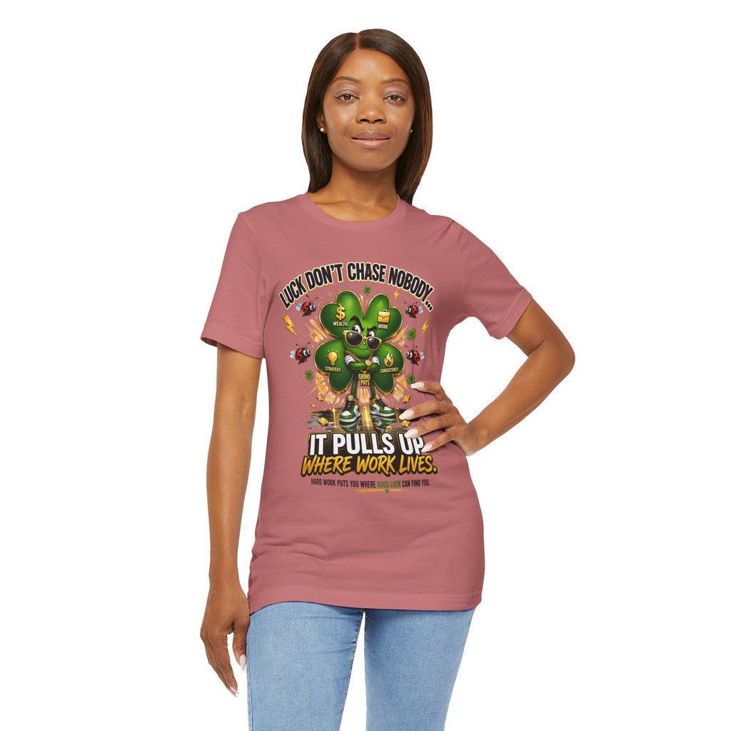 A woman wears the Lucky Clover "Pulls Up Lives" Graphic T-Shirt, featuring a cartoon four-leaf clover and playful slogan. Available in S-3XL, she poses confidently with a smile and hand on her hip.