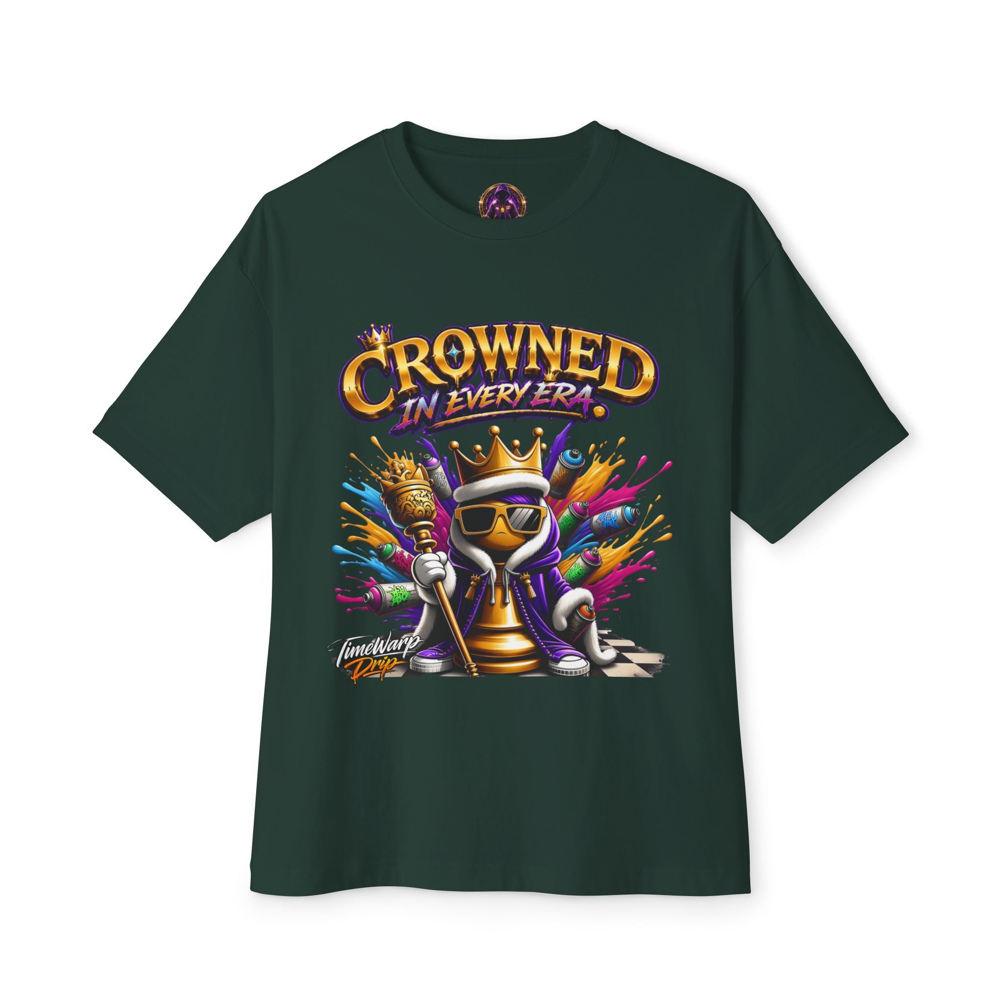 The Crowned In Every Era - Unisex Oversized Boxy Tee features a dark green, relaxed 100% airlume cotton fit. It sports a cartoon chess king with sunglasses and crown, plus bold “CROWNED IN EVERY ERA” text and colorful paint splashes.