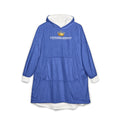 The "Crowned in Every Era" Royal Chess Graphic Hooded Blanket in royal blue features a soft white fleece lining, front pocket, and CROWNED ENERGY text with a gold crown graphic on the chest. One size fits most, perfect for lounging. Displayed on a white background.