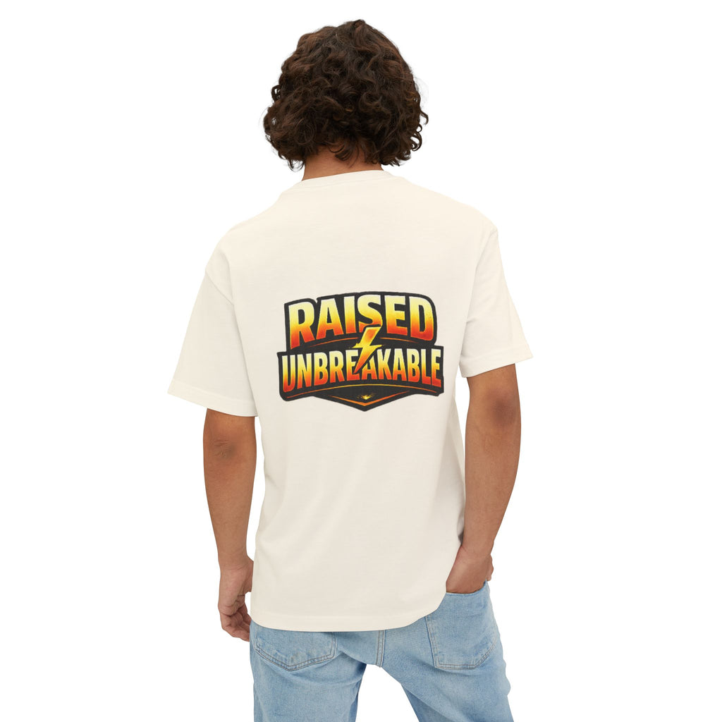 A curly-haired individual wears the TimeWarp Drip Generation X Parenting "Come Get Em" oversized boxy tee—white, breathable cotton with a bold RAISED UNBREAKABLE graphic and yellow lightning bolt on the back—styled with light blue jeans for Gen X vibes.