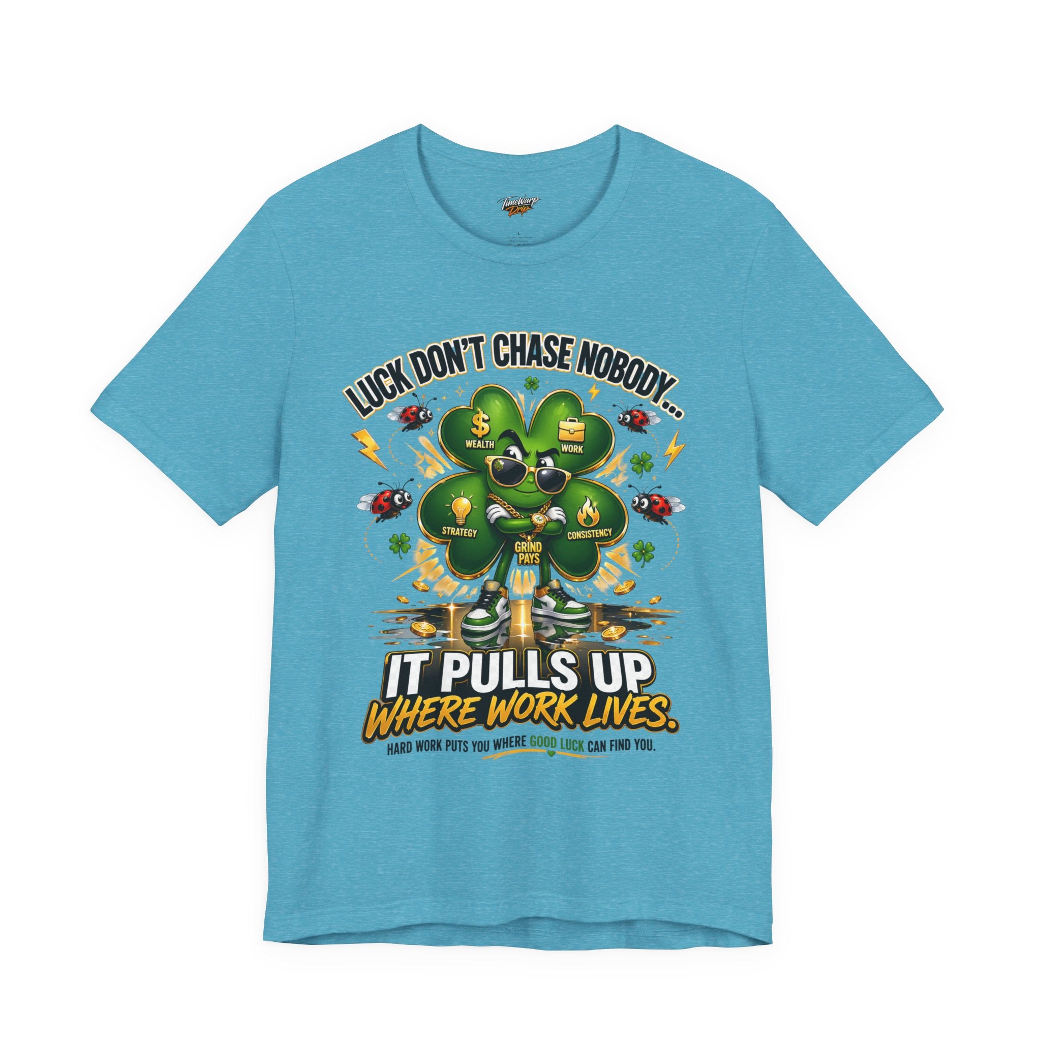 The Lucky Clover "Pulls Up Lives" Graphic T-Shirt, in blue and sizes S–XL plus widths, features a four-leaf clover with sunglasses among ladybugs and gold coins, and reads: “Luck don’t chase nobody... It pulls up where work lives.” Smaller text highlights hard work.