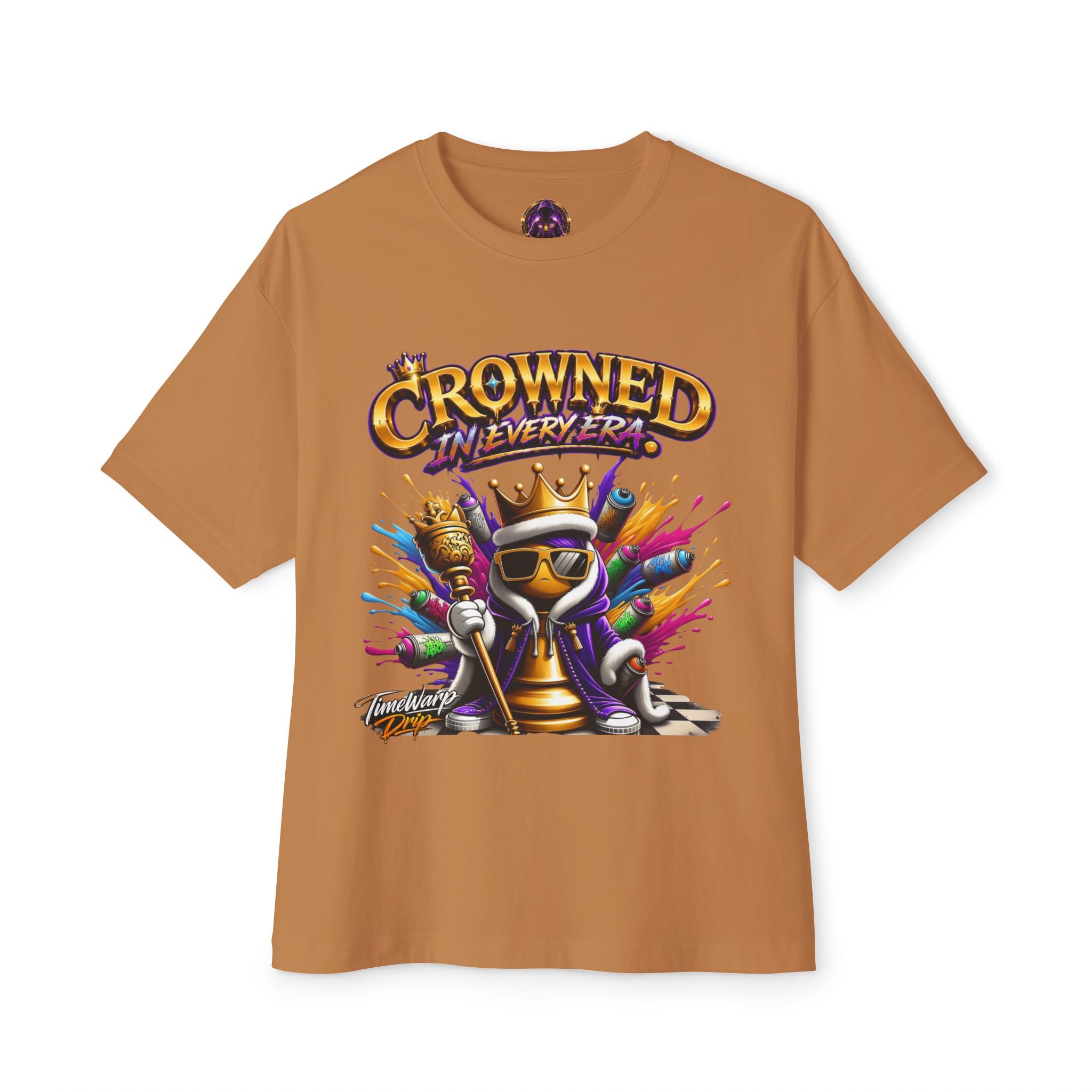 The "Crowned In Every Era" Unisex Oversized Boxy Tee features a light brown relaxed fit, 100% airlume cotton, and a cartoon chess king with sunglasses, crown, scepter, colorful splashes, and the text “Crowned In Every Era” above.