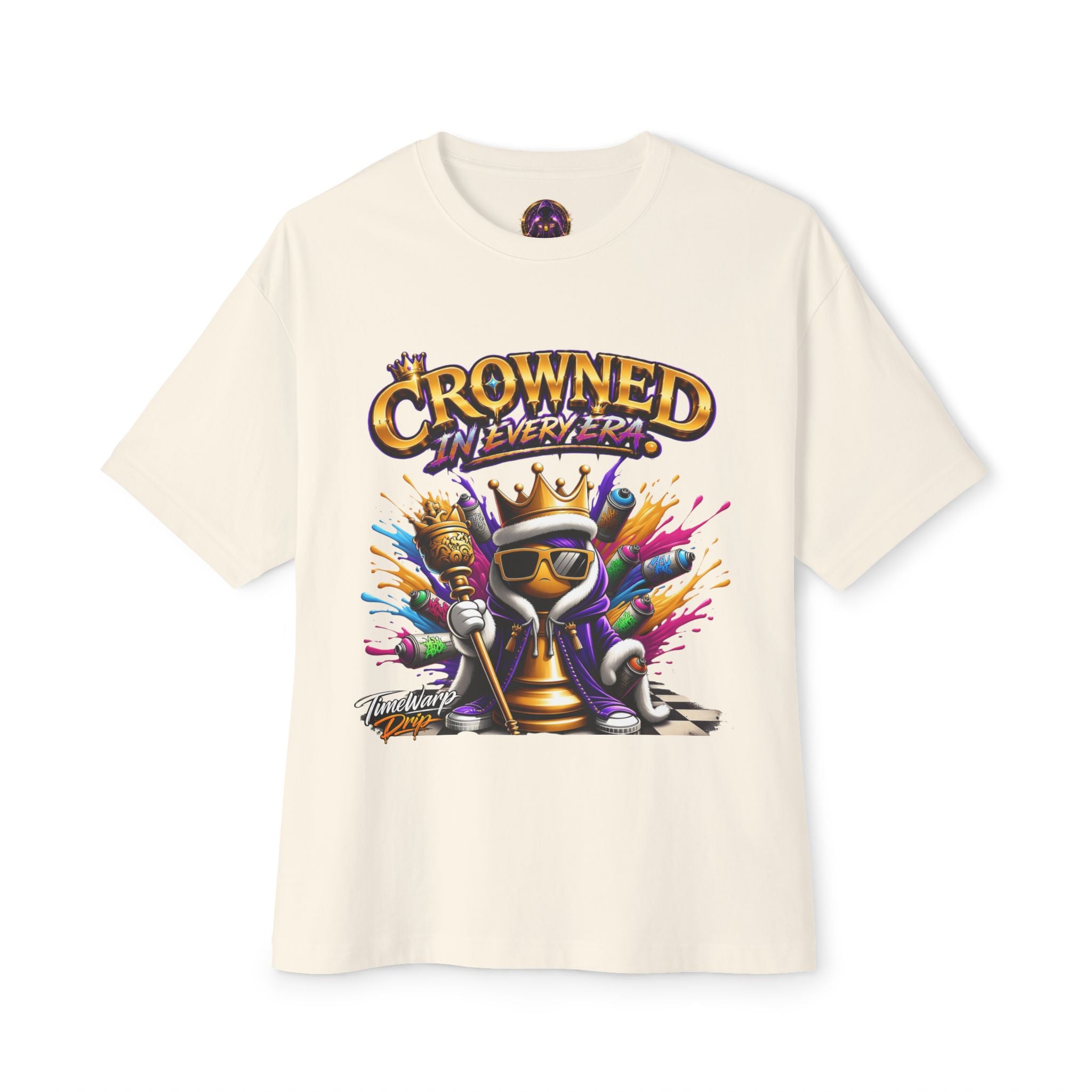 The Crowned In Every Era Unisex Oversized Boxy Tee features a crowned cartoon character with sunglasses, a cape, paintbrushes, and spray cans. Made from 100% airlume cotton in a relaxed boxy fit, it displays "Crowned in Every Era" above the design.