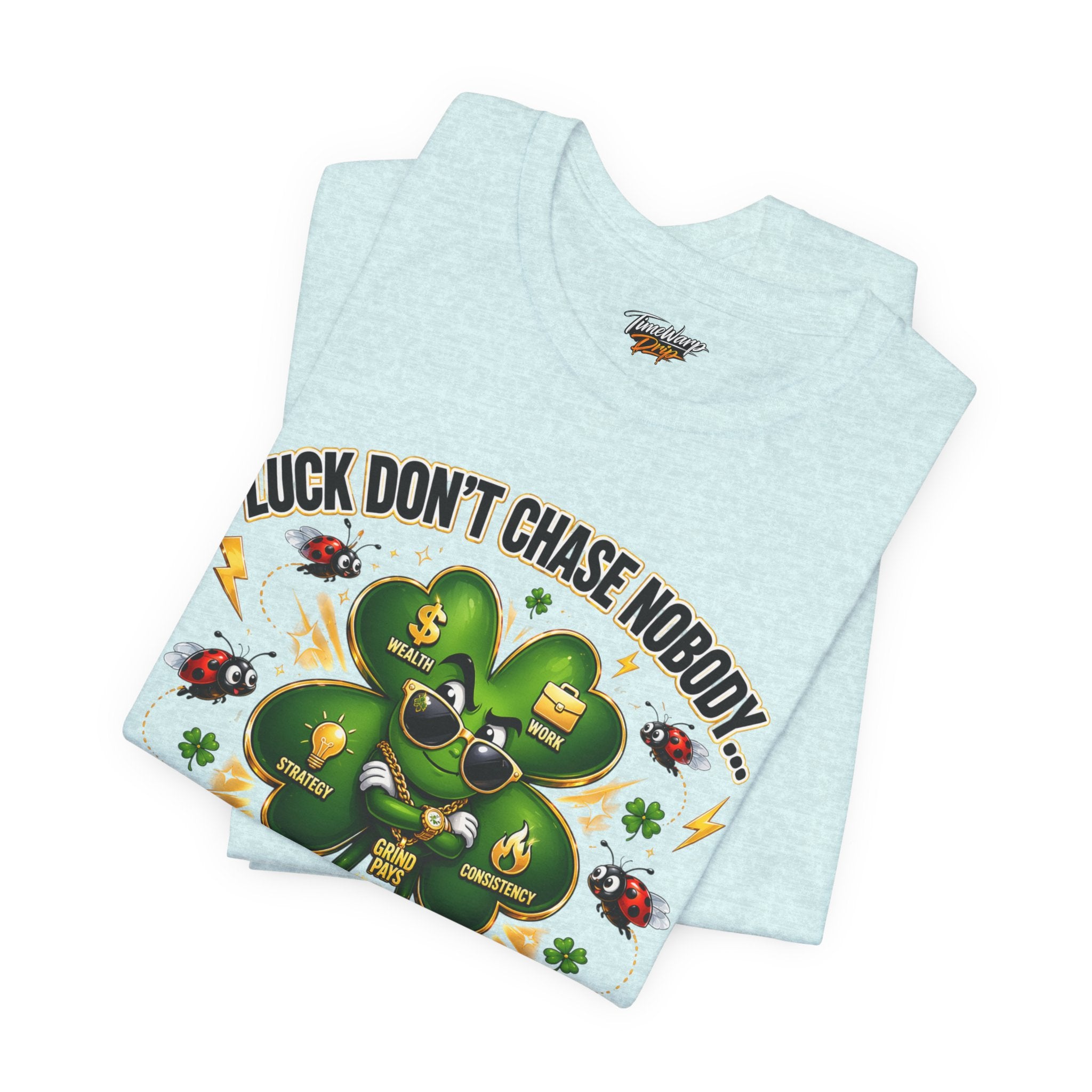 The TimeWarp Drip "Lucky Clover, Pulls Up Lives" Graphic T-Shirt features a cartoon clover in shades and gold chains with ladybugs, lightning bolts, and icons. Available in S-3XL light blue. Text: Luck don't chase nobody...