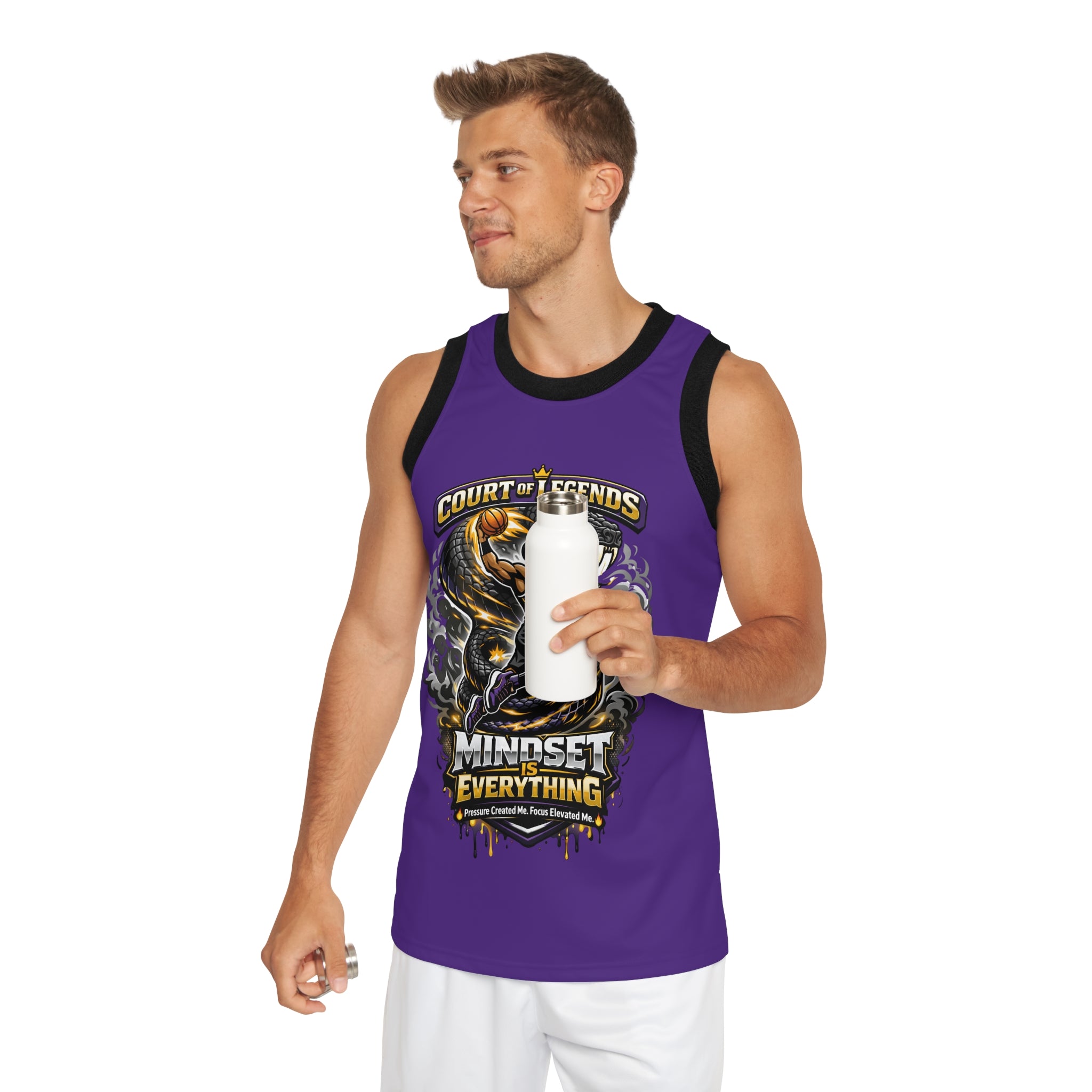 Wearing a Court of Legends - (Purple) Basketball Jersey with a "Mindset is Everything" graphic and unisex fit, a man smiles to the side holding a white water bottle. The moisture-wicking polyester keeps him cool.