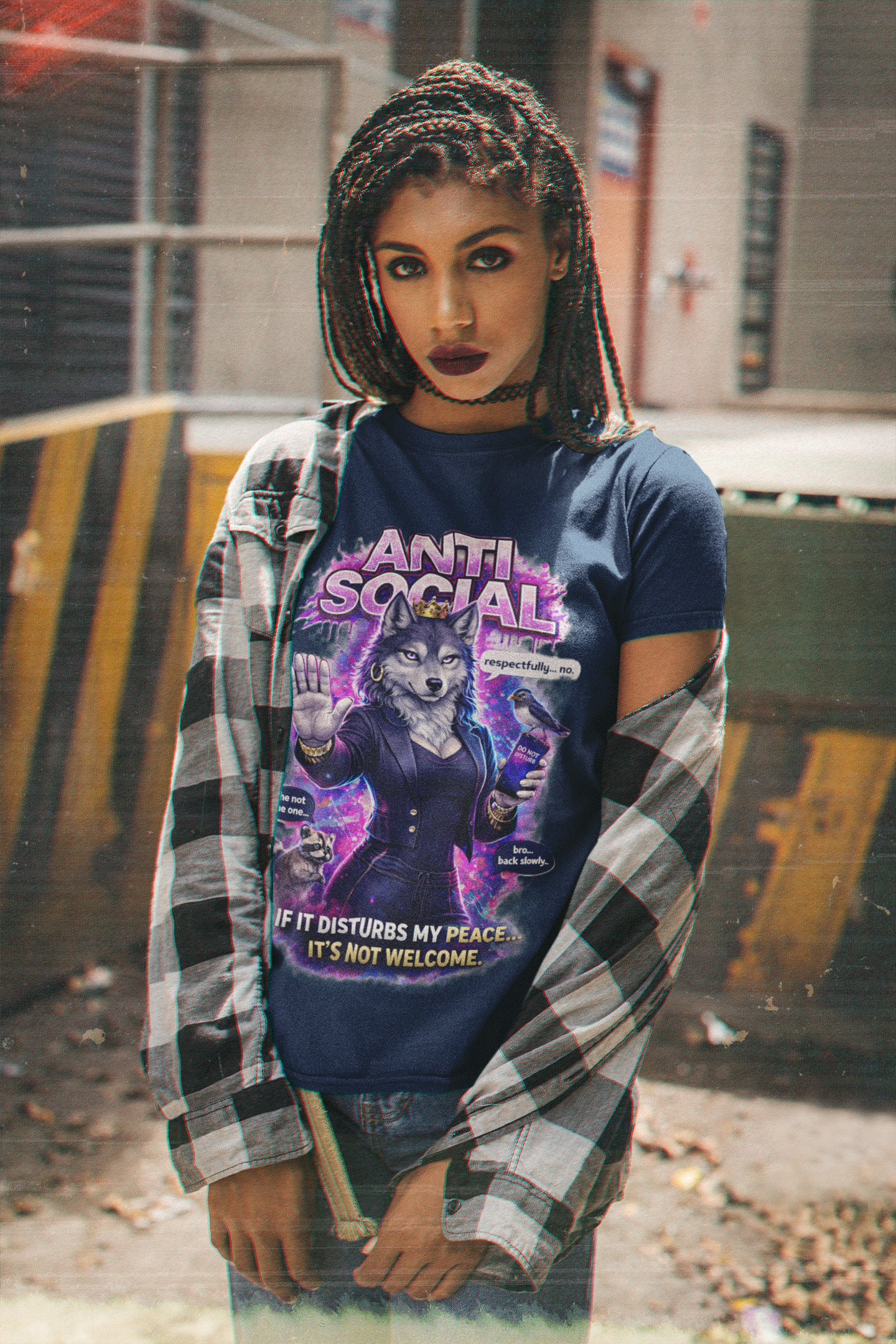 A woman with braided hair and dark lipstick stands outdoors, wearing the Anti Social She-Wolf T-Shirt—a funny introvert graphic tee with a wolf illustration—paired with a plaid shirt draped over her shoulders.