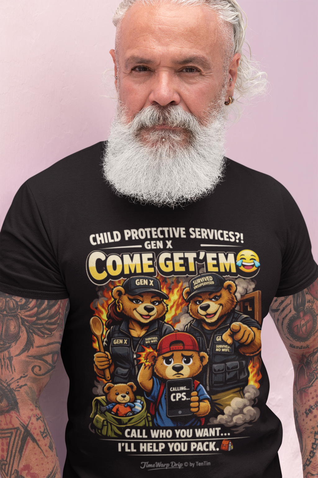 A bearded man with white hair and tattoos wears TimeWarp Drip’s Generation X Parenting "Come Get Em" Oversized Boxy T-Shirt, a breathable cotton tee featuring cartoon bears in tactical gear and the humorous quote: “Call who you want... I’ll help you pack.”.