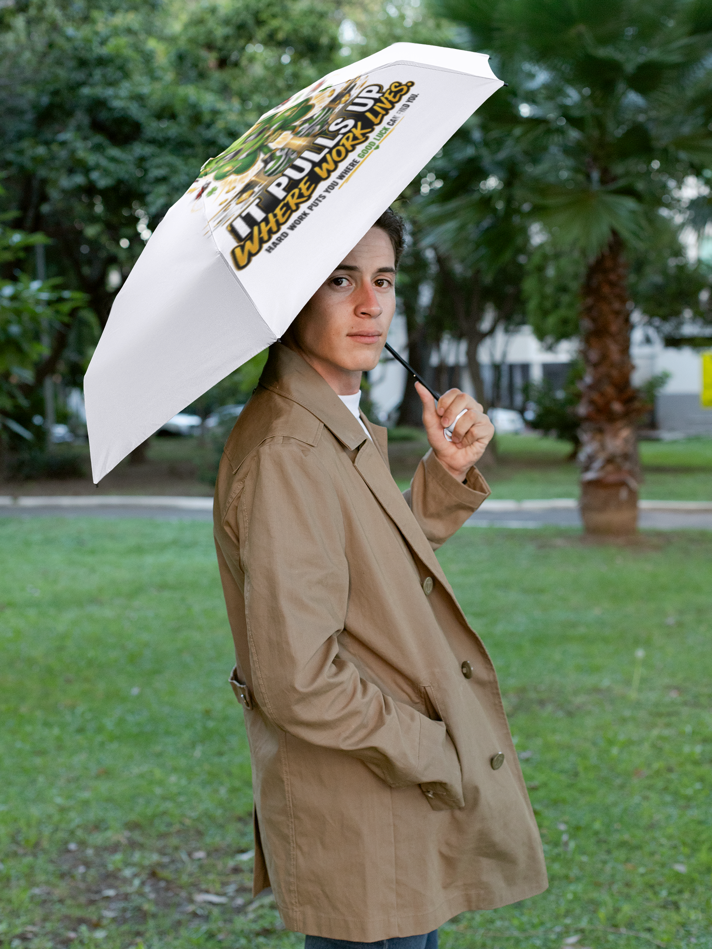 TimeWarp Drip Tan-coat trendsetter rocks Printify’s Lucky Clover white foldable umbrella—streetwise, bold, and fresh in the park. streetwear apparel