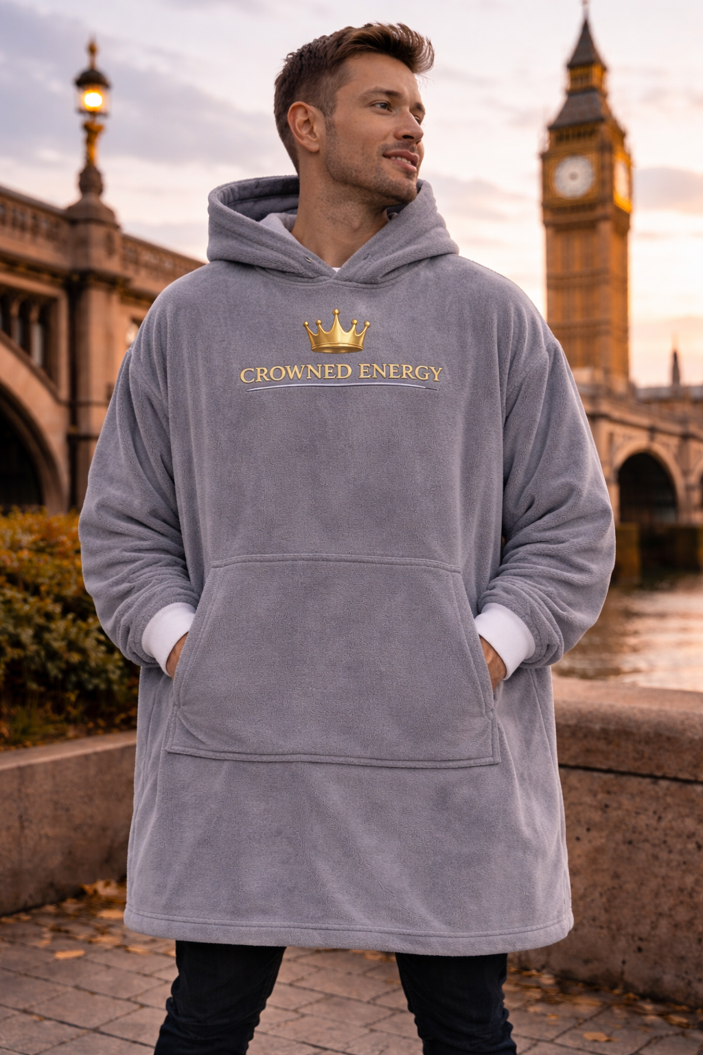 TimeWarp Drip Strut the Thames in a gray "Crowned in Every Era" Printify hooded blanket—one size, pure streetwear royalty at sunset. streetwear apparel