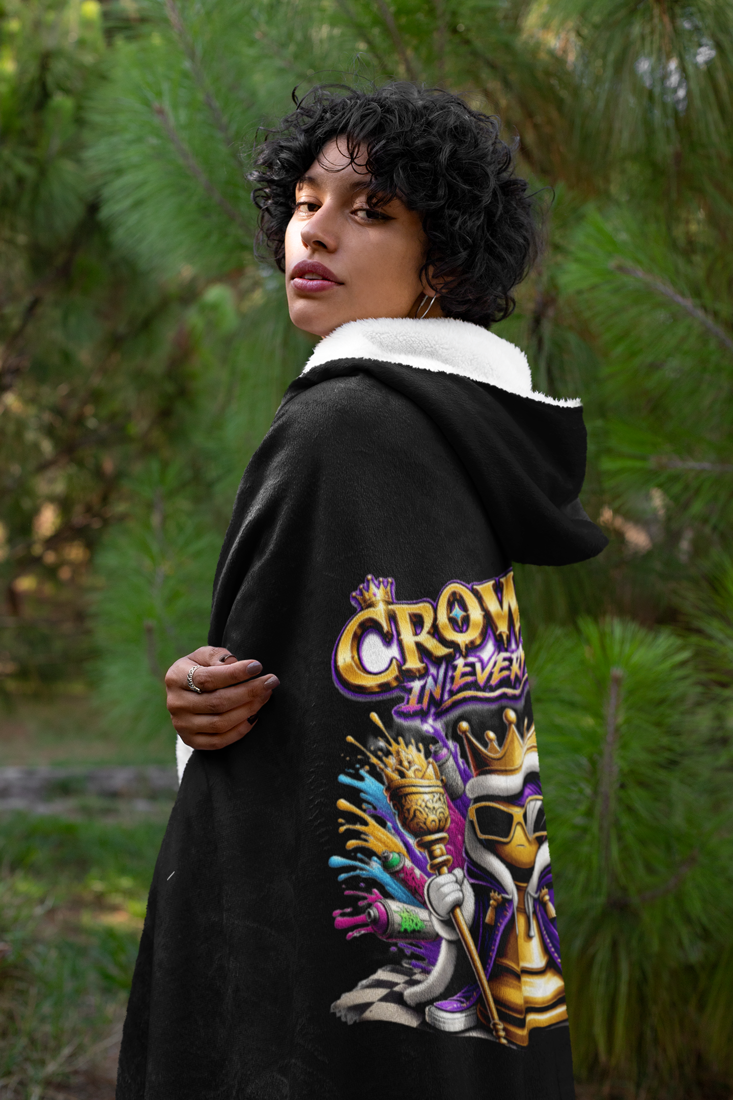 TimeWarp Drip Strut the scene in the "Crowned in Every Era" black hooded blanket—TimeWarp Drip’s streetwear royalty, ruling among the trees. streetwear apparel