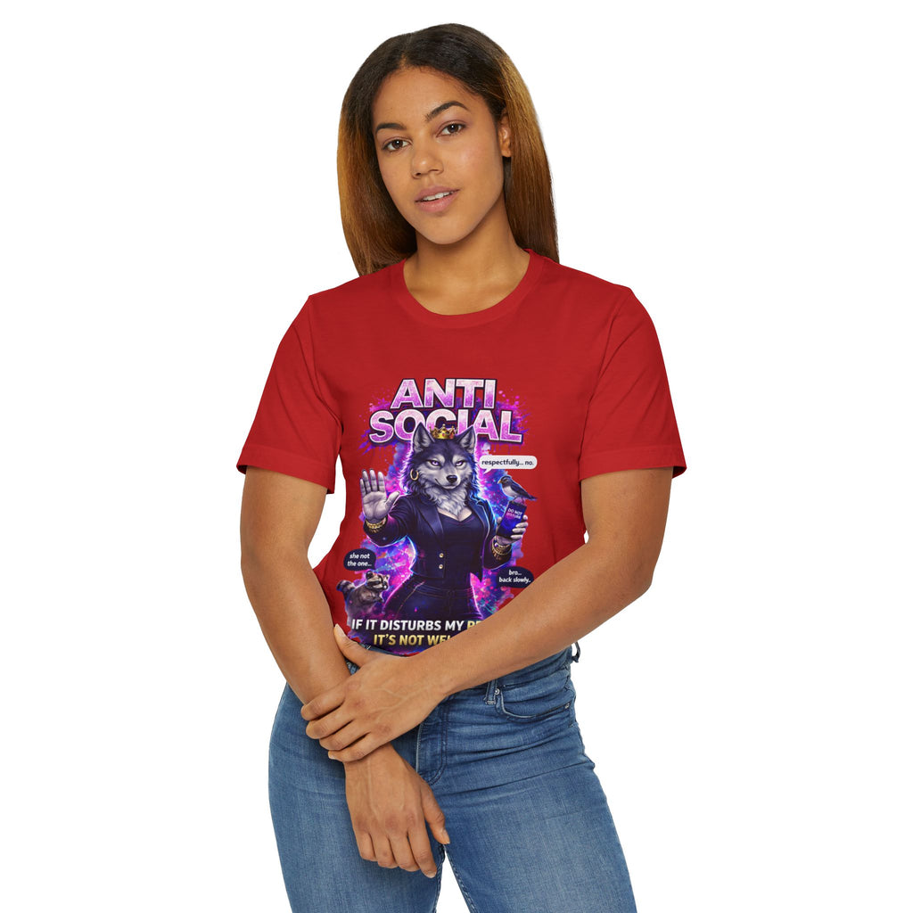 A woman with straight brown hair wears the Anti Social She-Wolf T-Shirt— a red funny introvert graphic tee featuring colorful text and a she-wolf image. She stands against a plain white background.