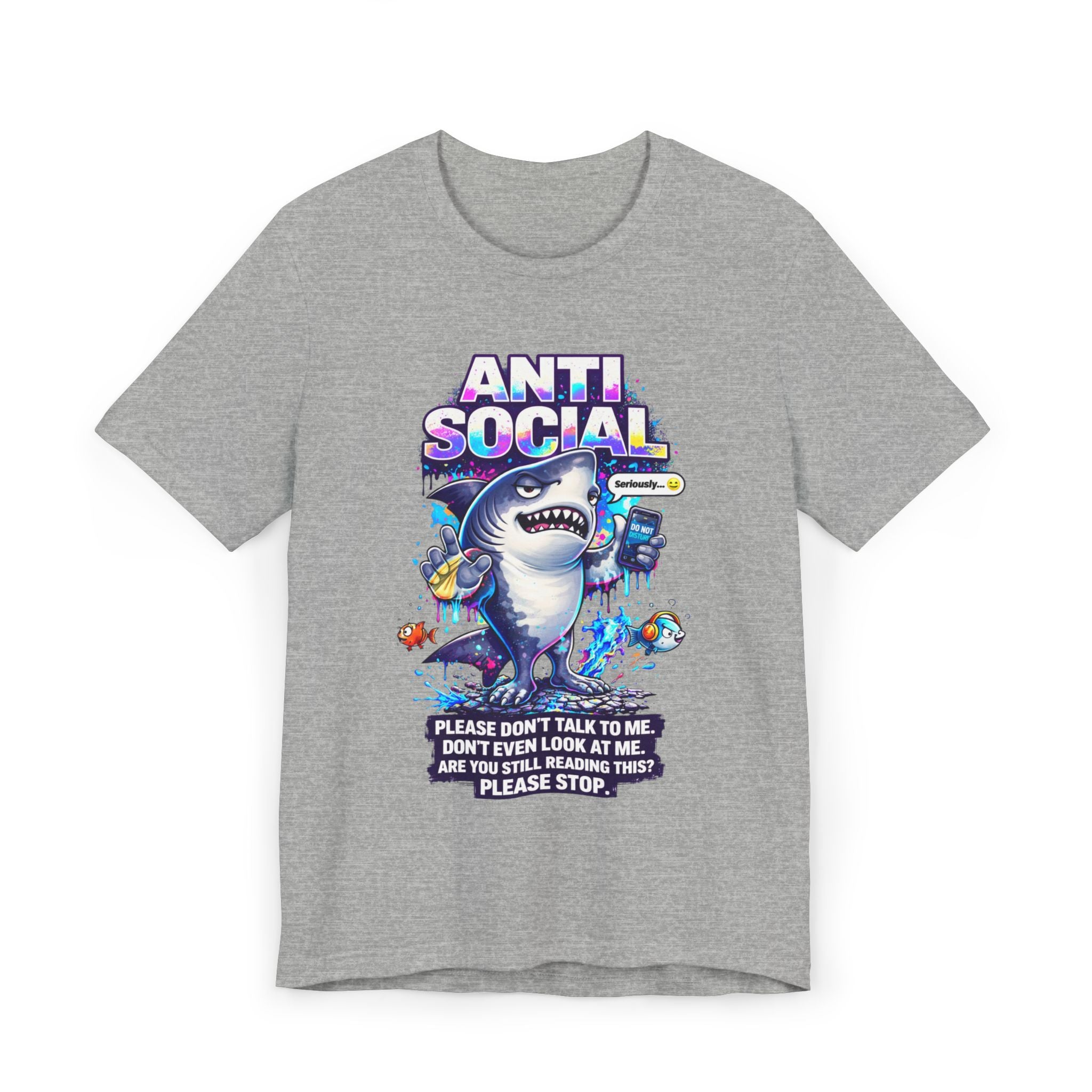 The Anti Social Shark T-Shirt — Funny Introvert Graphic Tee is a gray unisex cotton shirt with a cartoon shark holding a phone, surrounded by fish and playful text: "Please don’t talk to me. Don’t even look at me. Are you still reading this?.