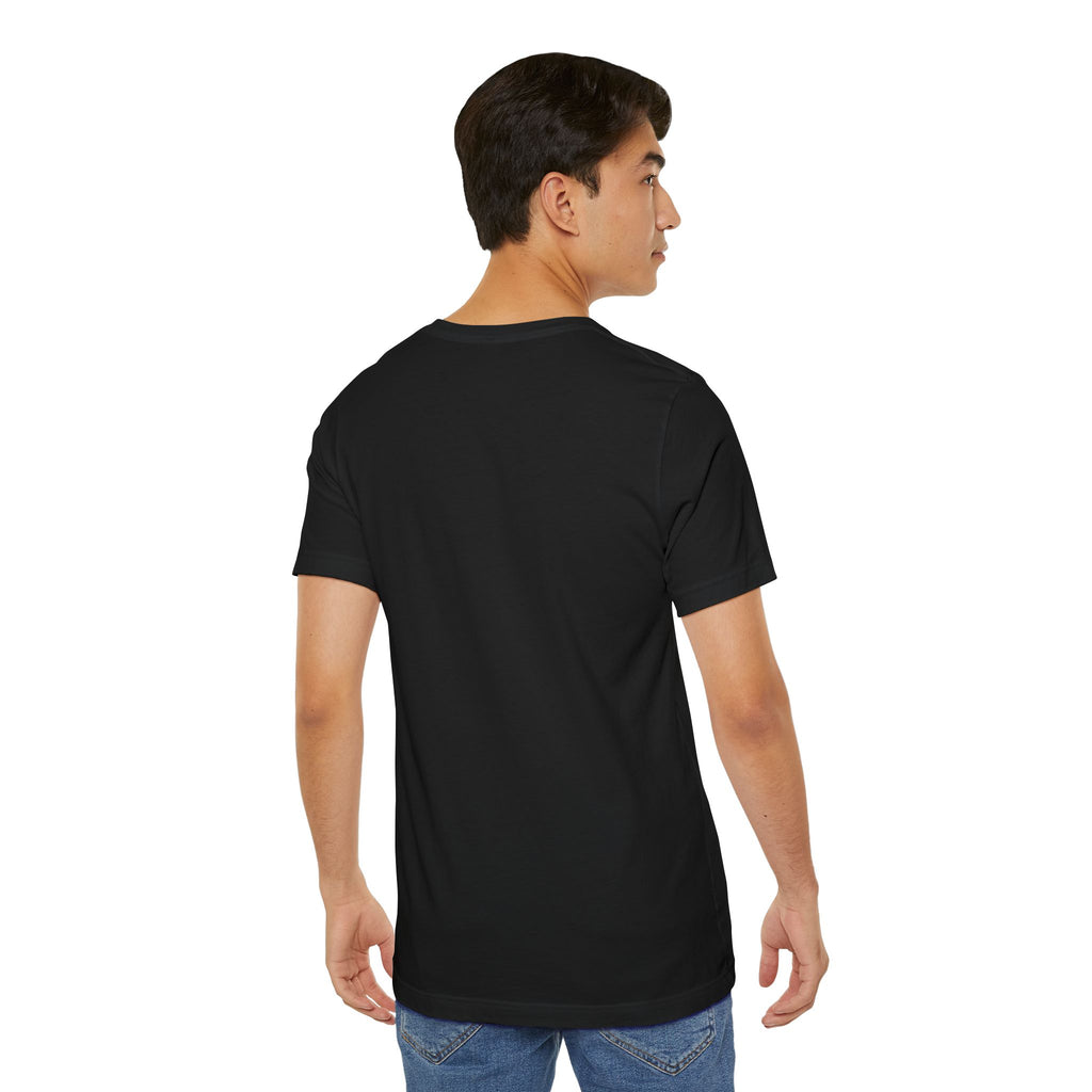 A young man with short dark hair, wearing an Anti Social Shark T-Shirt — Funny Introvert Graphic Tee and blue jeans, stands with his back to the camera against a white background.