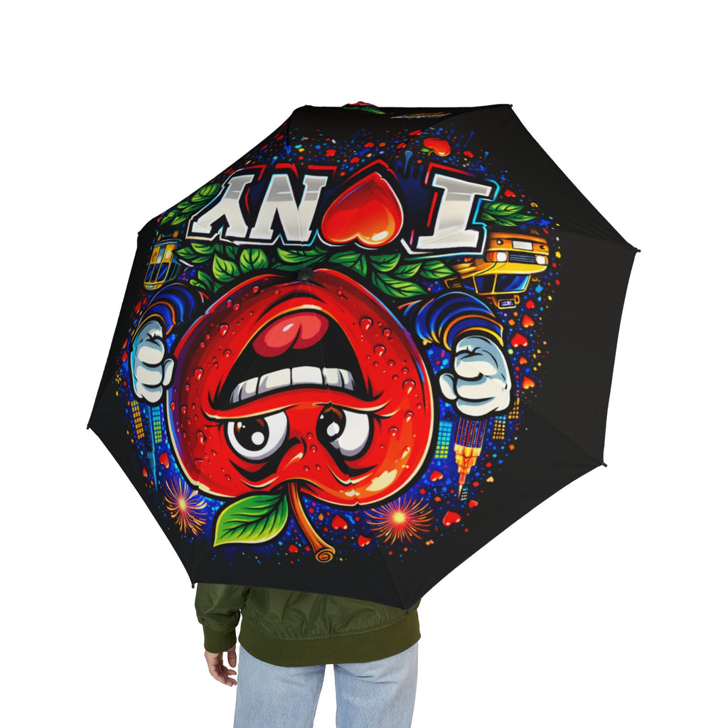 A person holds the I Love NYC - Foldable Umbrella by TimeWarp Drip: a black, one-size, semi-automatic rain umbrella with a colorful design featuring a mischievous red apple, bold "NYC," cityscape elements, and fireworks.