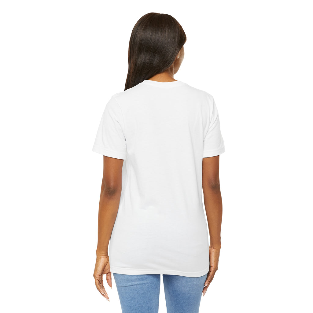 A woman with long dark hair faces away from the camera, wearing the Lucky Clover "Pulls Up Lives" Graphic T-Shirt by TimeWarp Drip and light blue jeans. Available in sizes S–3XL.