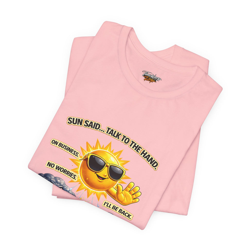 The Calm Energy Vibes T-Shirt — "I Run the Forecast" CEO Energy by Printify is a folded pink lightweight tee with a cartoon sun in sunglasses and playful text, made from ultra-soft Airlume cotton for everyday comfort.