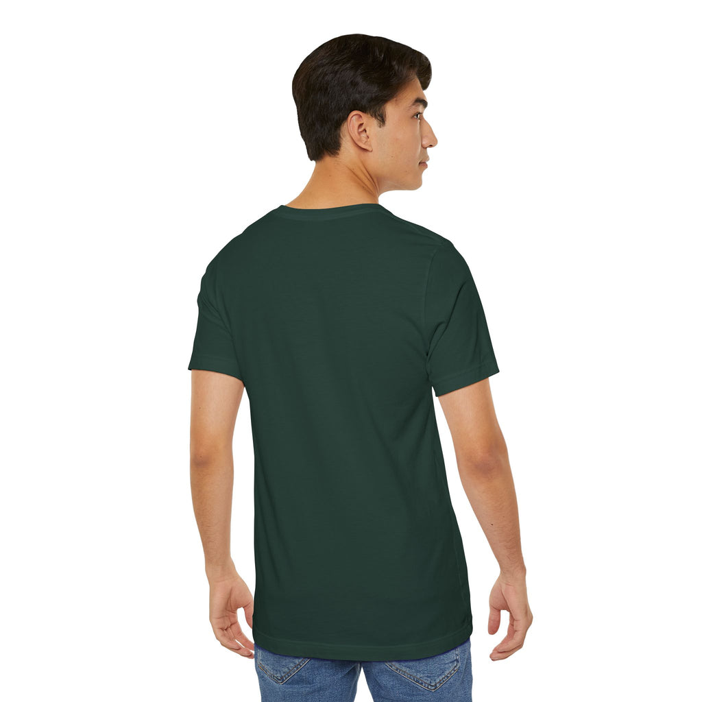 A young man with short dark hair is standing against a plain white background, facing away from the camera and looking slightly right. He’s wearing blue jeans and an Anti Social Shark T-Shirt — Funny Introvert Graphic Tee.