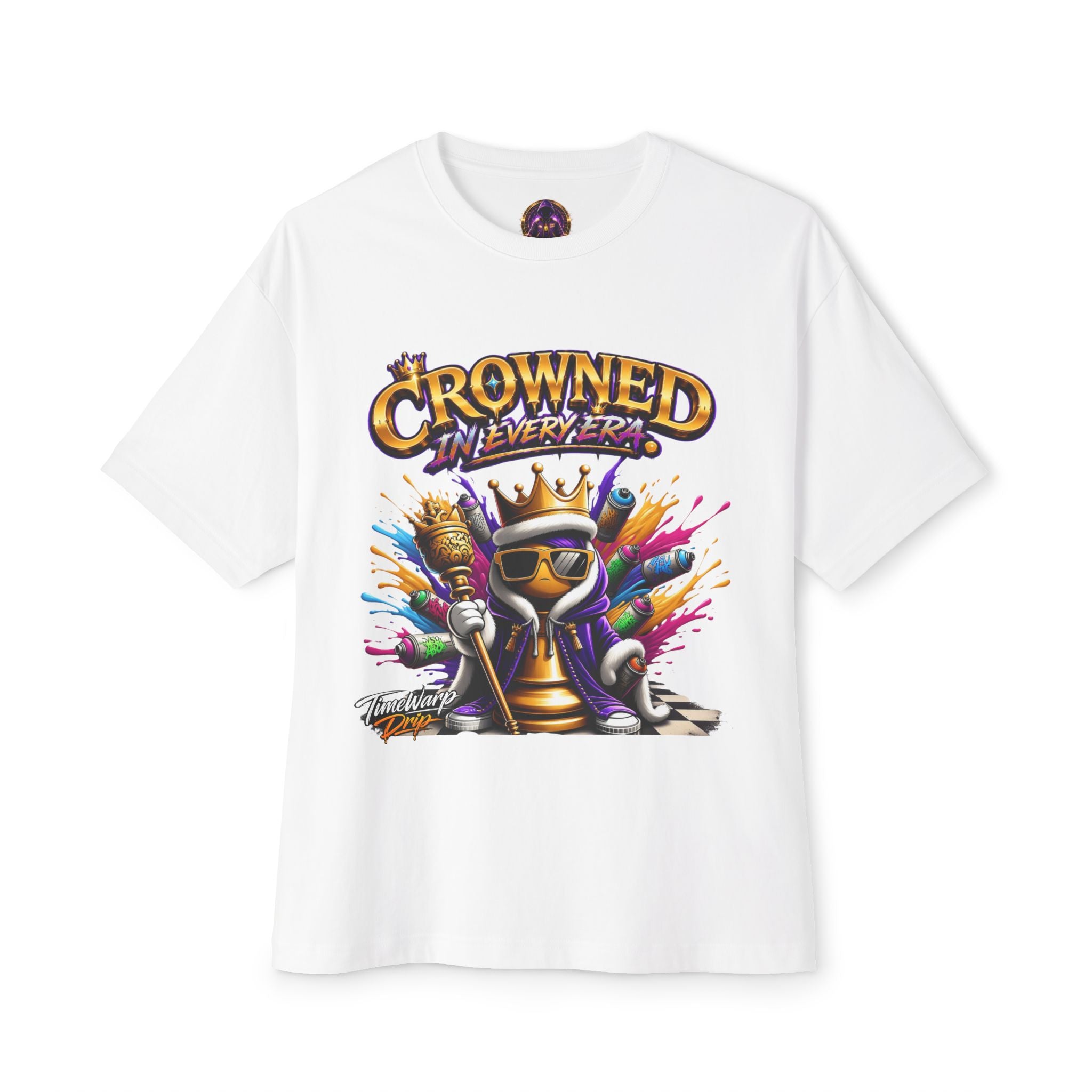 The Crowned In Every Era - Unisex Oversized Boxy Tee features a vibrant cartoon character with crown, sunglasses, and scepter on white 100% airlume cotton. "CROWNED IN EVERY ERA" is boldly printed above in yellow and purple. Relaxed boxy fit.