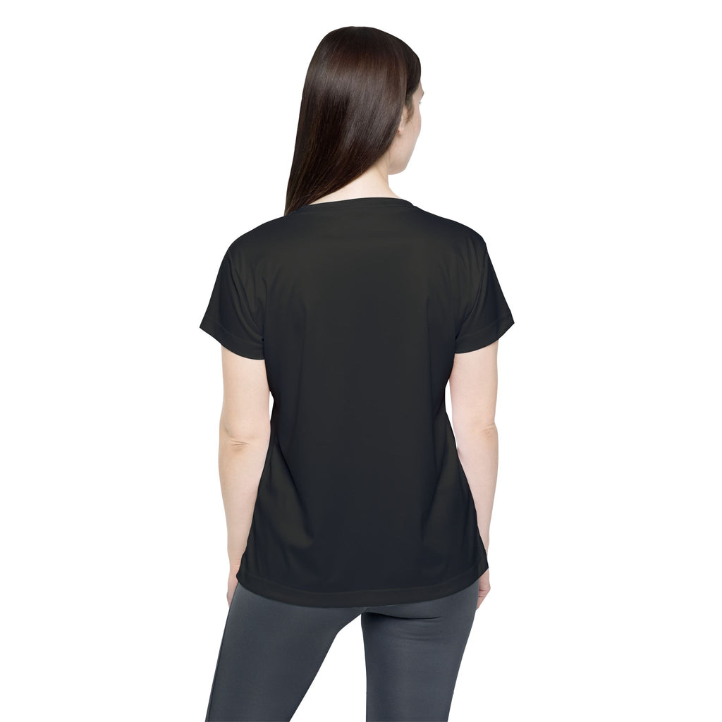 A woman with long brown hair, seen from the back, wears Printify’s Straight Outta Baltimore — Women's Sports Jersey (Black Charm City Fan Tee) and dark leggings against a white background.